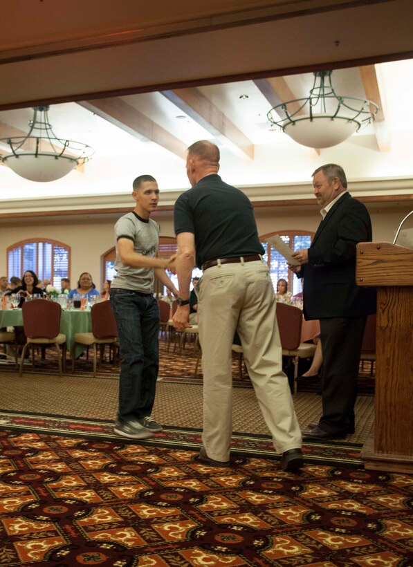 Marine Corps Air Station Yuma's Commanding Officer Col. Robert C. Kuckuk and MCAS Yuma Deacon David Sampson, of the station chapel, hand out volunteer appreciation certificates at the 12th annual Volunteer Appreciation Night on station May 2. The appreciation event was held to recognize volunteers who help with programs such as Navy Marine Corps Relief Society, youth sports, the Single Marine Program and the station chapel.