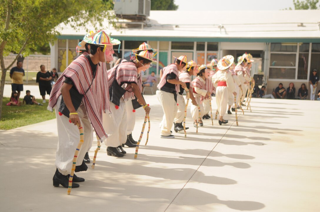 Marines from Marine Attack Squadron 211, Marine Aircraft Group 13, Third Marine Aircraft Wing, based out of Marine Corps Air Station Yuma, watched their adopted students at George Carver Elementary school perform traditional Mexican heritage performances as part of their end of the school year Cinco De Mayo bash, May 3. Students donned masks as part of an amusing piece based on Mexican folklore and tradition.