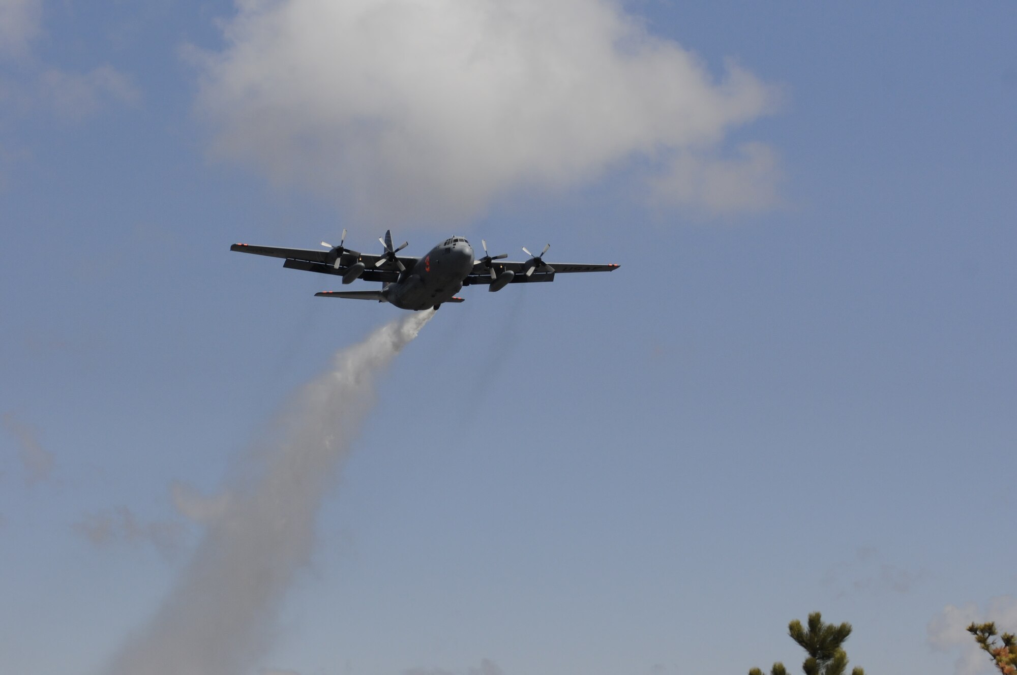 A Modular Airborne Fire Fighting System-equipped C-130 from the 153rd Airlift Wing, after following a U.S. Forest Service lead plane, performs a training mission which includes water drops near the Medicine Bow National Forest, May 10, 2013. The Wyoming Air National Guard's 153rd AW held its annual MAFFS certification and re-certification training. When it is determined MAFFS is needed, the National Interagency Fire Center through U.S. Northern Command requests the Department of Defense's U.S. Air Force resources. (U.S. Air National Guard photo by Capt. Rusty Ridley)