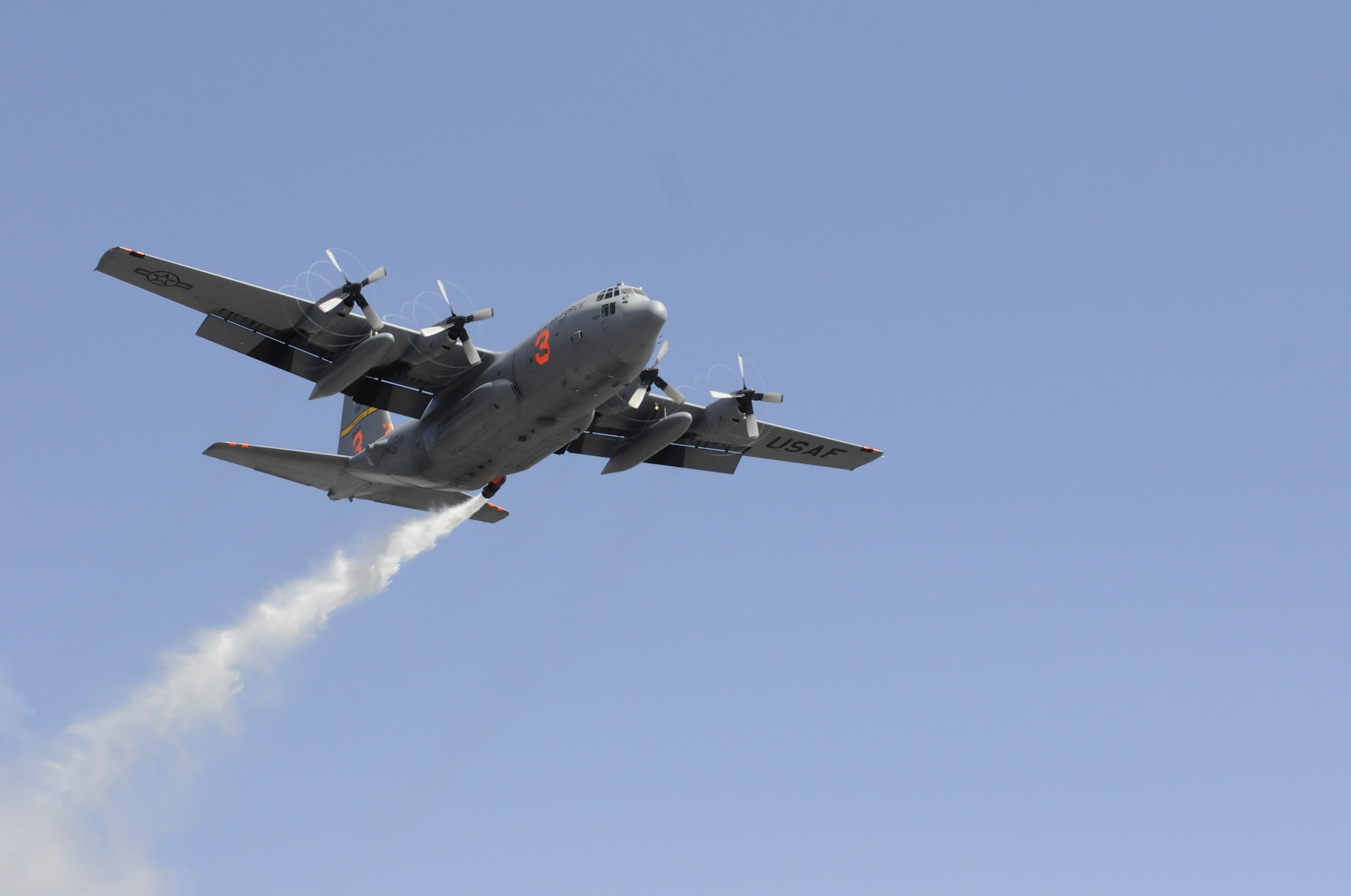 A Modular Airborne Fire Fighting System-equipped C-130 from the 153rd Airlift Wing, after following a U.S. Forest Service lead plane, performs a training mission which includes water drops near the Medicine Bow National Forest, May 10, 2013. The Wyoming Air National Guard's 153rd AW held its annual MAFFS certification and re-certification training. When it is determined MAFFS is needed, the National Interagency Fire Center through U.S. Northern Command requests the Department of Defense's U.S. Air Force resources. (U.S. Air National Guard photo by Capt. Rusty Ridley)