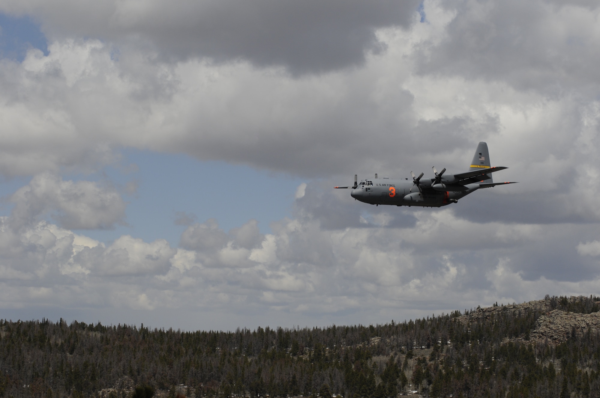 A Modular Airborne Fire Fighting System-equipped C-130 from the 153rd Airlift Wing, after following a U.S. Forest Service lead plane, performs a training mission which includes water drops near the Medicine Bow National Forest, May 10, 2013. The Wyoming Air National Guard's 153rd AW held its annual MAFFS certification and re-certification training. When it is determined MAFFS is needed, the National Interagency Fire Center through U.S. Northern Command requests the Department of Defense's U.S. Air Force resources. (U.S. Air National Guard photo by Capt. Rusty Ridley)