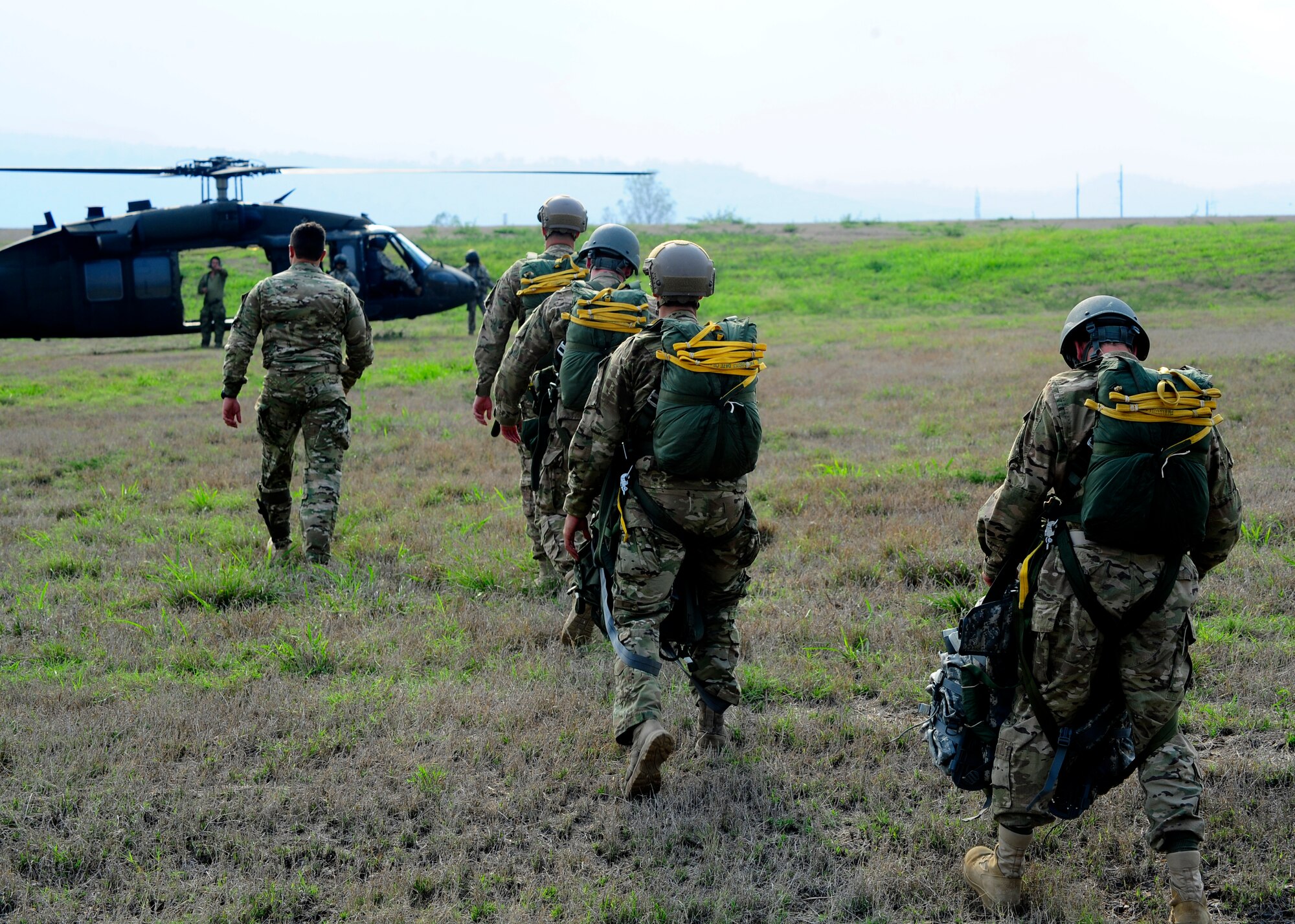 U.S. Army paratroopers walk to the waiting UH-60 Blackhawk for a static line proficiency training jump at Soto Cano Air Base, Honduras, April 30. The paratroops must make a minimum of 4 jumps a year to stay proficient. (Air Force photo by Staff Sgt. Eric Donner) 