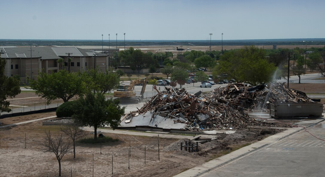 Demolition work continues on building 257, which formally housed the base Library, post office, official mail center and marketing at Laughlin Air Force Base, Texas, May 10, 2013. The building is being destroyed as part of the Air Force’s goal of reducing utilities and maintenance costs 20 percent by the year 2020. Laughlin has selected 24 buildings, whose original work centers can be consolidated elsewhere, for demolition, saving $377,000 annually as part of the cost conscious culture. (U.S. Air Force photo/Airman 1st Class Jimmie D. Pike)