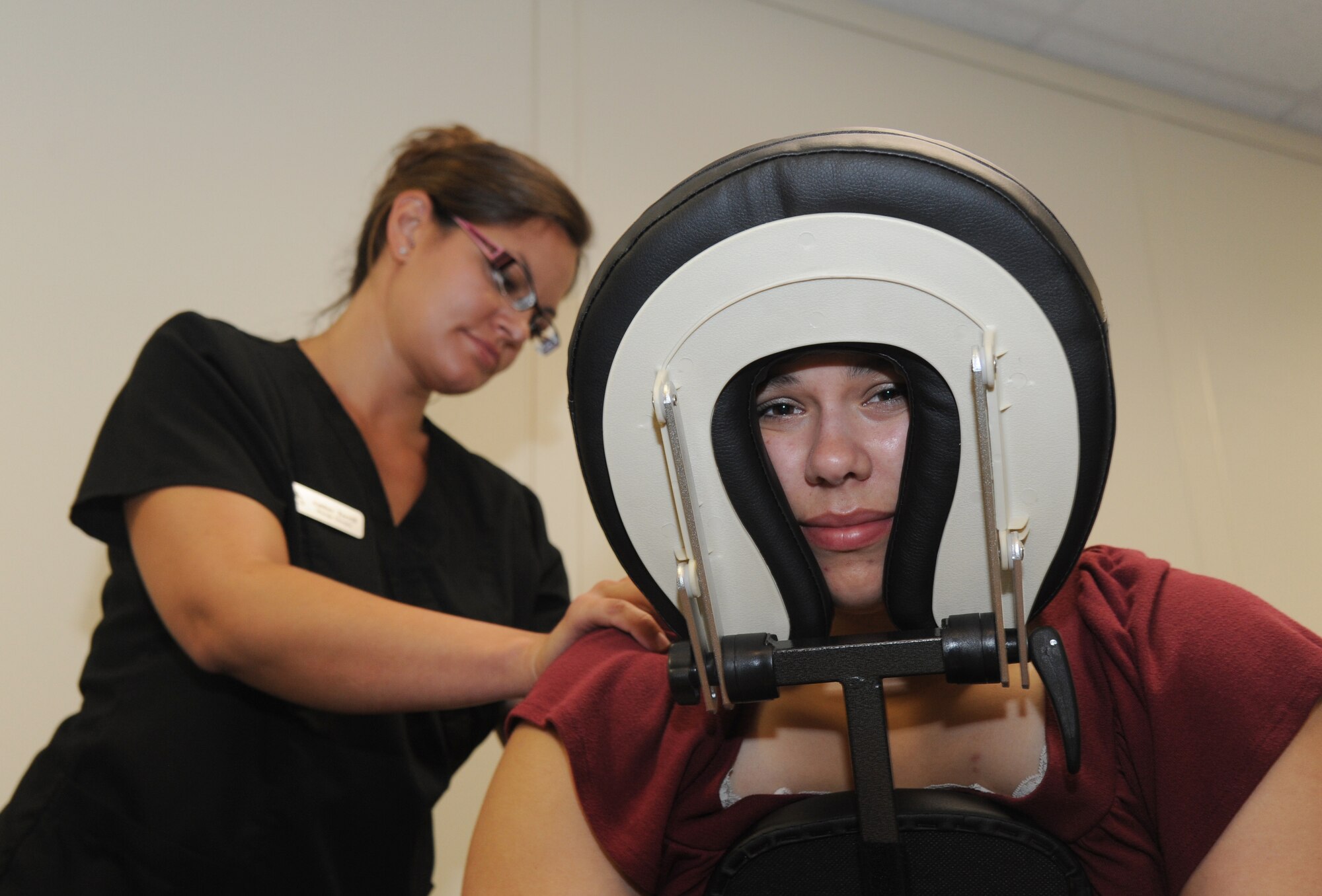 Amber Terrill, massage therapist, gives a massage to Jennifer, spouse of Staff Sgt. Carlos Caldera, 81st Medical Operations Squadron, during Pamper Me Day for military spouses May 9, 2013, at the Sablich Center, Keesler Air Force Base, Miss.  Keesler’s Airman & family readiness center has hosted the event for the past nine years, offering spouses free manicures, hair styling, makeup, or a 15-20 minute massage.   (U.S. Air Force photo by Kemberly Groue)