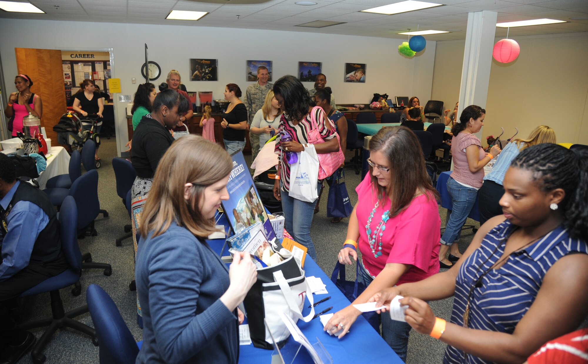 Spouses view informational awareness and business booths during Pamper Me Day for military spouses May 9, 2013, at the Sablich Center, Keesler Air Force Base, Miss.  Keesler’s Airman & family readiness center has hosted the event for the past nine years, offering spouses free manicures, hair styling, makeup, or a 15-20 minute massage.  (U.S. Air Force photo by Kemberly Groue)