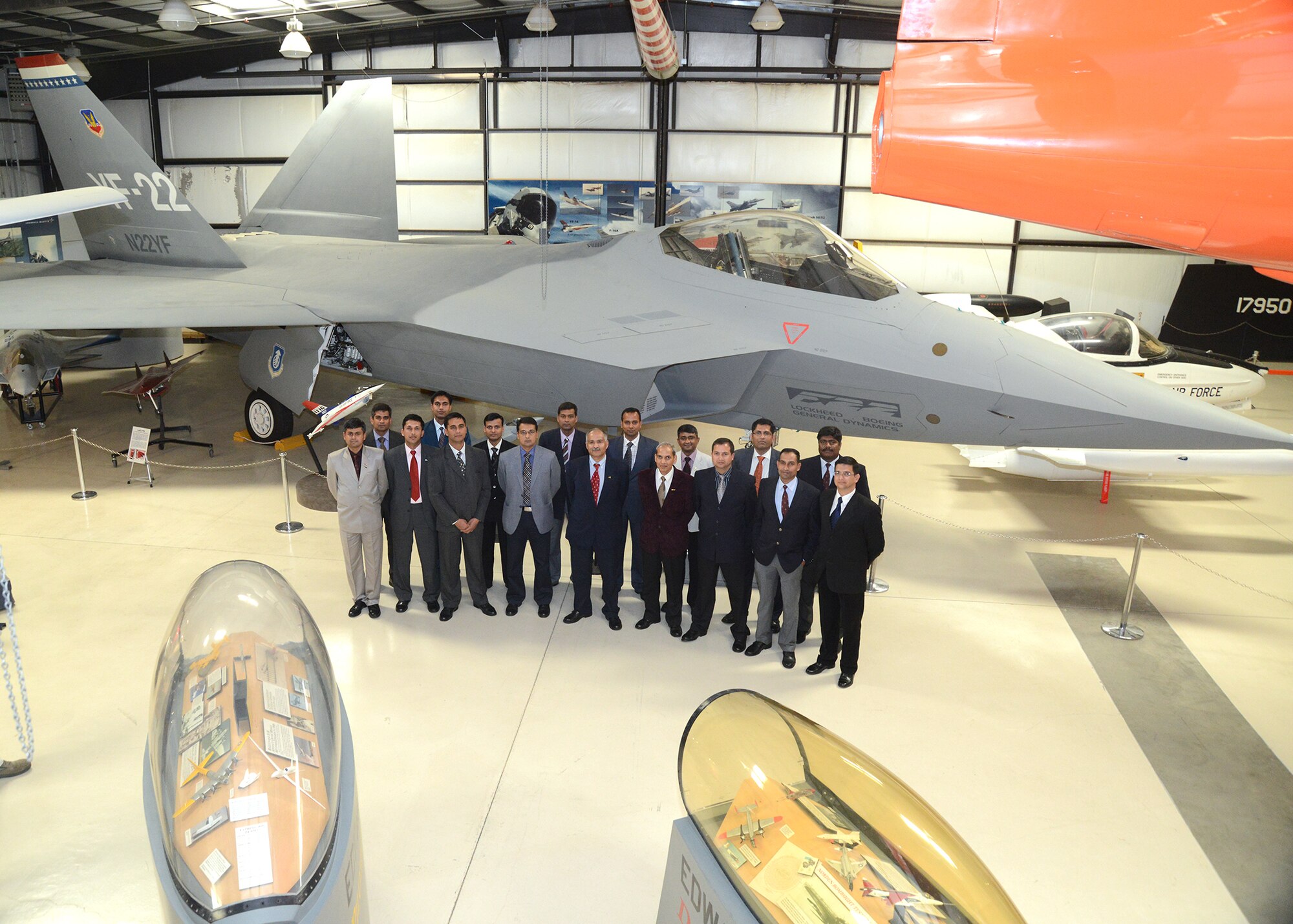 Seventeen members of the senior class from India's Test Pilot School pose for a photo in front of the YF-22 at the Air Force Flight Test Museum. The YF-22 was the prototype built that would later lead to the development of the F-22 Raptor. (U.S. Air Force photo by Kenji Thuloweit)