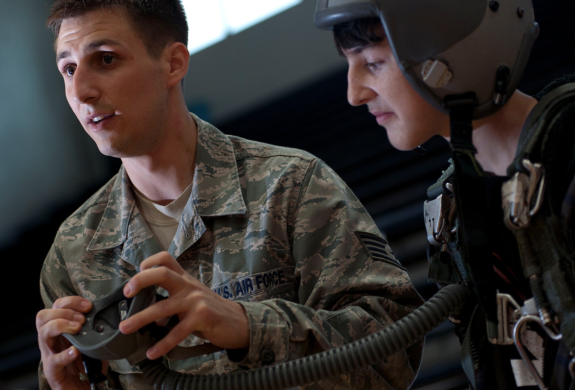 ALTUS, Okla. – Staff Sgt. Blaque Kuchel, 97th Operations Support Squadron unit deployment manager, shows A.J. Strom, a student from Altus Intermediate School, the importance of aircrew flight equipment during the Science, Technology, Engineering, and Math fair at Altus High School, May 9. The STEM fair was open to students in the Altus area from grades 6-12. The event was created to encourage student to pursue careers in the STEM field and give them a chance to experience those careers first hand. (U.S. Air Force Photo by Senior Airman Jesse Lopez / Released)