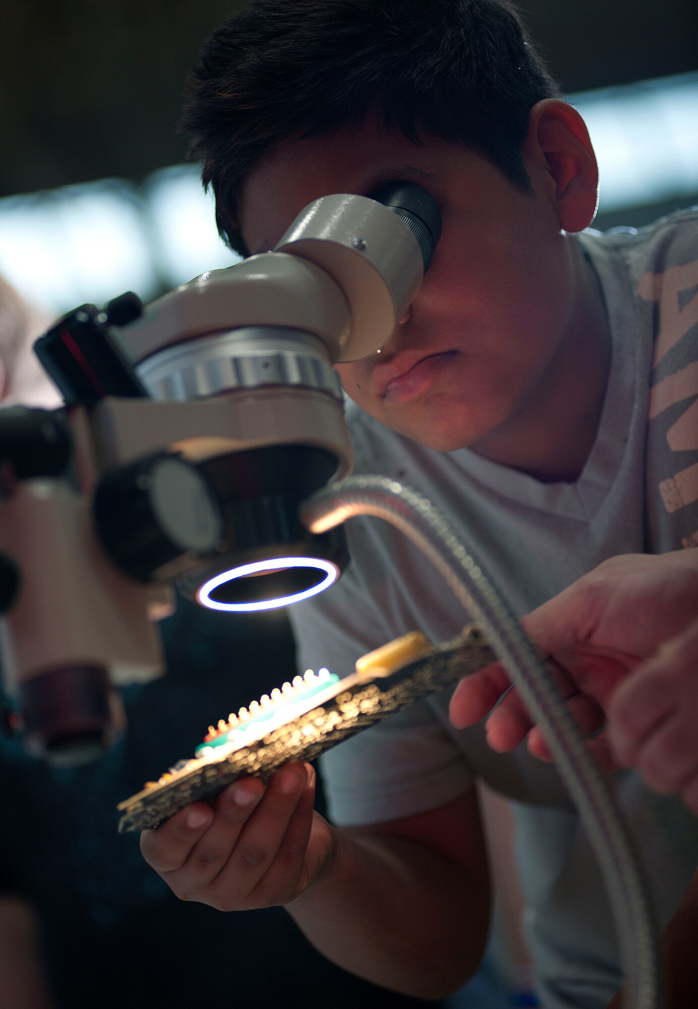 ALTUS, Okla. – DeAngelo Balcorta, a student from Altus Intermediate School, looks at computer parts through a microscope during the Science, Technology, Engineering, and Mathematics Fair at Altus High School, May 9. Airmen from various squadrons of Altus Air Force Base and local businesses worked together to host the STEM fair. The Air Force’s pursuit to strategize partnerships and outreach activities with schools, universities and professional associations will help to grow the STEM workforce of the future. (U.S. Air Force Photo by Senior Airman Jesse Lopez / Released)