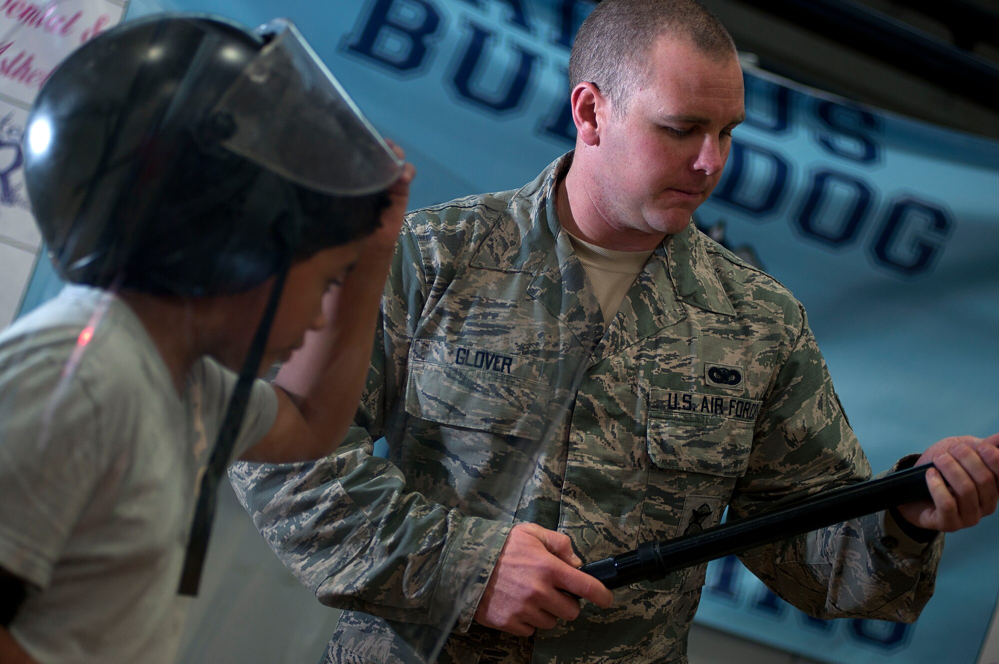 ALTUS, Okla. – Senior Airman Timothy Glover, 97th Security Forces response team member, shows riot gear and its uses to DeAngelo Balcorta, a student from Altus Intermediate School, during the Science, Technology, Engineering, and Mathematics Fair at Altus High School, May 9. Airmen from various squadrons of Altus Air Force Base and local businesses worked together to host the STEM fair, which was open to students in the Altus area from grades 6-12. The event was created to encourage student to pursue careers in the STEM field and give them a chance to experience those careers first hand. (U.S. Air Force Photo by Senior Airman Jesse Lopez / Released)