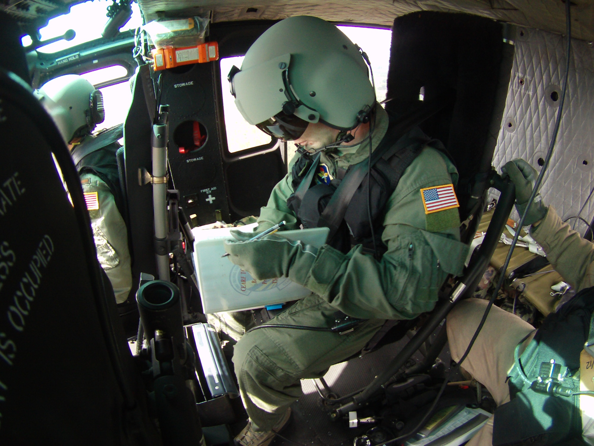 Senior Airman Brian Doyle computes take-off and landing data during his first Career Enlisted Aviator Rotary Wing Fundamentals training flight. (Courtesy photo)