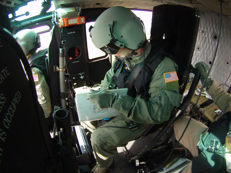 Senior Airman Brian Doyle computes take-off and landing data during his first Career Enlisted Aviator Rotary Wing Fundamentals training flight. (Courtesy photo)