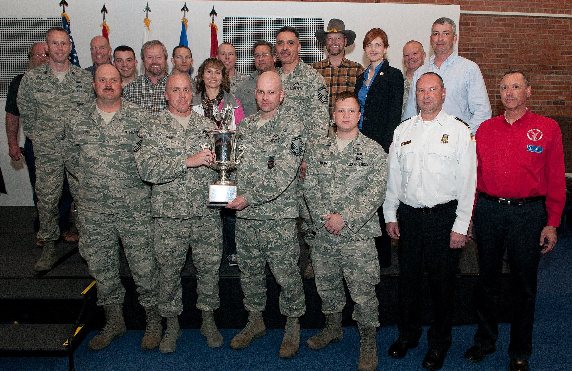 Members of the 90th Civil Engineer Squadron pose with the Cheyenne Trophy during an award luncheon in the Fall Hall Community Center here May 3. The trophy is presented by the Cheyenne Chamber of Commerce Military Affairs Committee in recognition of the 90th CES as an outstanding unit picked by F. E. Warren Air Force Base leadership. (U.S. Air Force photo by R.J. Oriez)