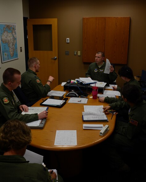 Airmen of the 109th Aeromedical Evacuation Squadron receive the mission brief from 1st Lt. Kirk Sutton, center, in St. Paul, Minn., May 8, 2013. Sutton is making sure that all the Airmen are up to date on the latest information about the patients, weather, and any simulated threats that they may encounter during their training flight.
(U.S. Air Force photo by Tech. Sgt. Amy M. Lovgren/Released) 
