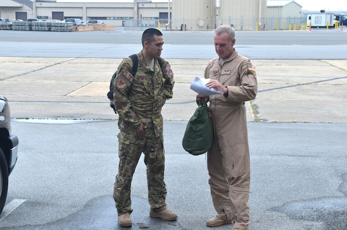 Air Force Tech. Sgt. Gabriel Garcia-Diaz, left, and Maj. Mark Baxa, each from the 181st Airlift Squadron, 136th Airlift Wing, Texas Air National Guard, talk near the flightline at the New Castle ANG base on May 9, 2013, upon their return home aboard a C-130 aircraft from the 136th AW. The Airmen travelled home with additional Airmen from their Texas unit and half-a-dozen Airmen from the Delaware ANG. They completed deployments that began in late February to the Southwest Asia combat zone where they served in support of Operation Enduring Freedom. A dozen more Delaware ANG Airmen are scheduled to return home in a Delaware C-130 Monday, May 13. The returning Delaware Air Guard Airmen are from two groups in the 166th Airlift Wing; the 166th Operations Group, which includes all C-130 aircrew and other Airmen with various critical job functions, and the 166th Maintenance Group, which includes crews who maintain and repair the aircraft. The Airmen are part of a contingent of about 100 unit Airmen flying and fixing C-130 aircraft for up to 120 days under U.S. Air Force Central Command, and can operate anywhere in USCENTCOM's 20-nation area of responsibility. (U.S. Air National Guard photo by Tech. Sgt. Benjamin Matwey)