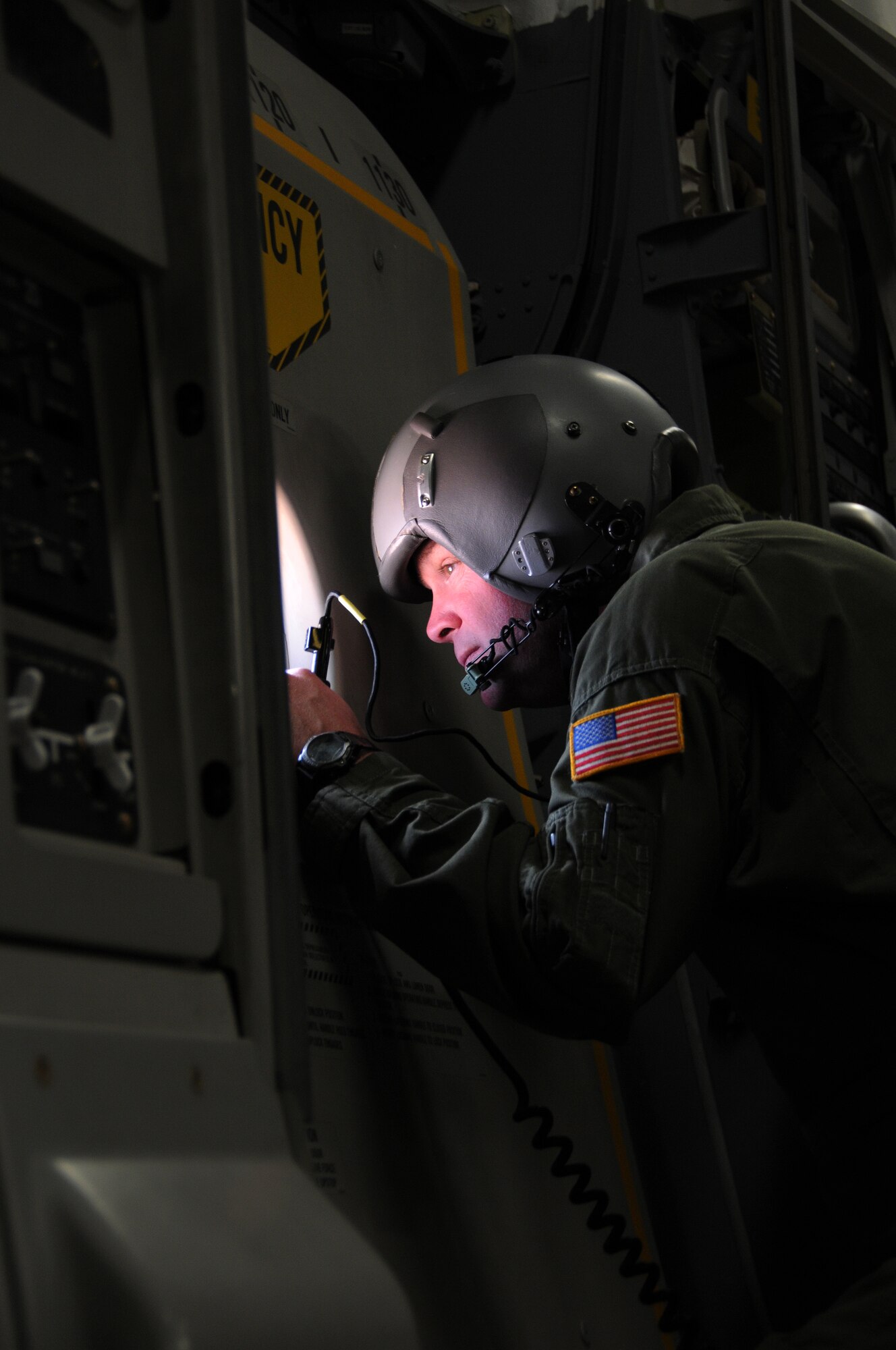 Master Sgt. Michael Folker, 326th Airlift Squadron loadmaster, Dover Air Force Base, Del., peers outside the window of a C-17 Globemaster during a training mission over Nellis Air Force Base, Nev., May 4, 2013. The mission served to test the necessity of incorporating a noncombatant evacuation operation into future Red Flag exercises. (U.S. Air Force photo by Senior Airman Erika Brooke)
