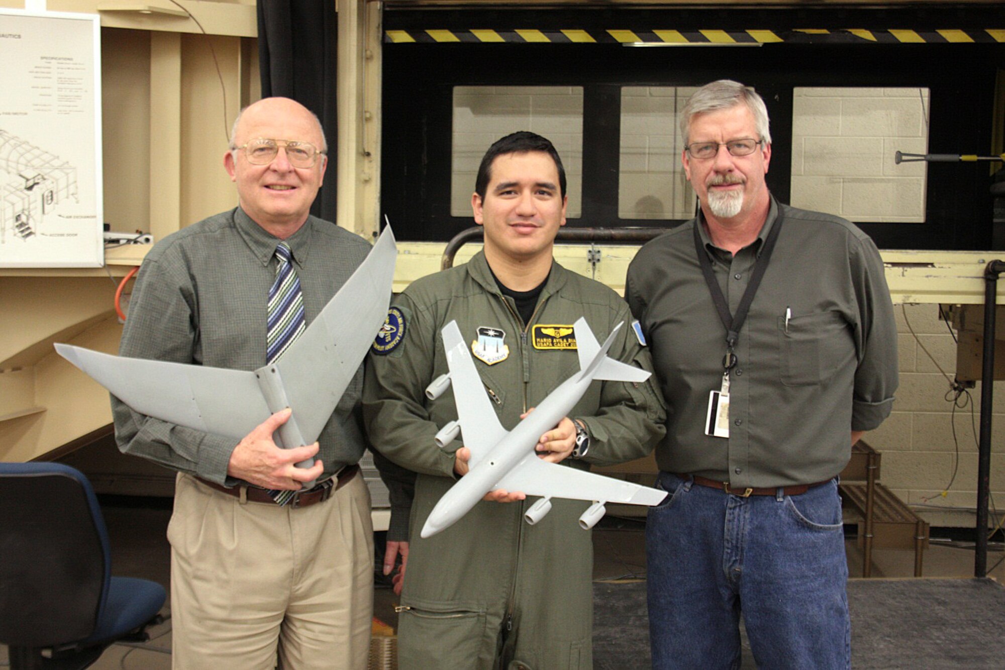 From left: Air Force Academy aeronautics professor Dr. Thomas Yechout, Mario Avila Diaz and Ken Ostasiewski pose with two wind tunnel models used to optimize the rakelet concept. Avila Diaz is a Guatemalan exchange cadet who graduated from the Academy in 2011. (U.S. Air Force photo)