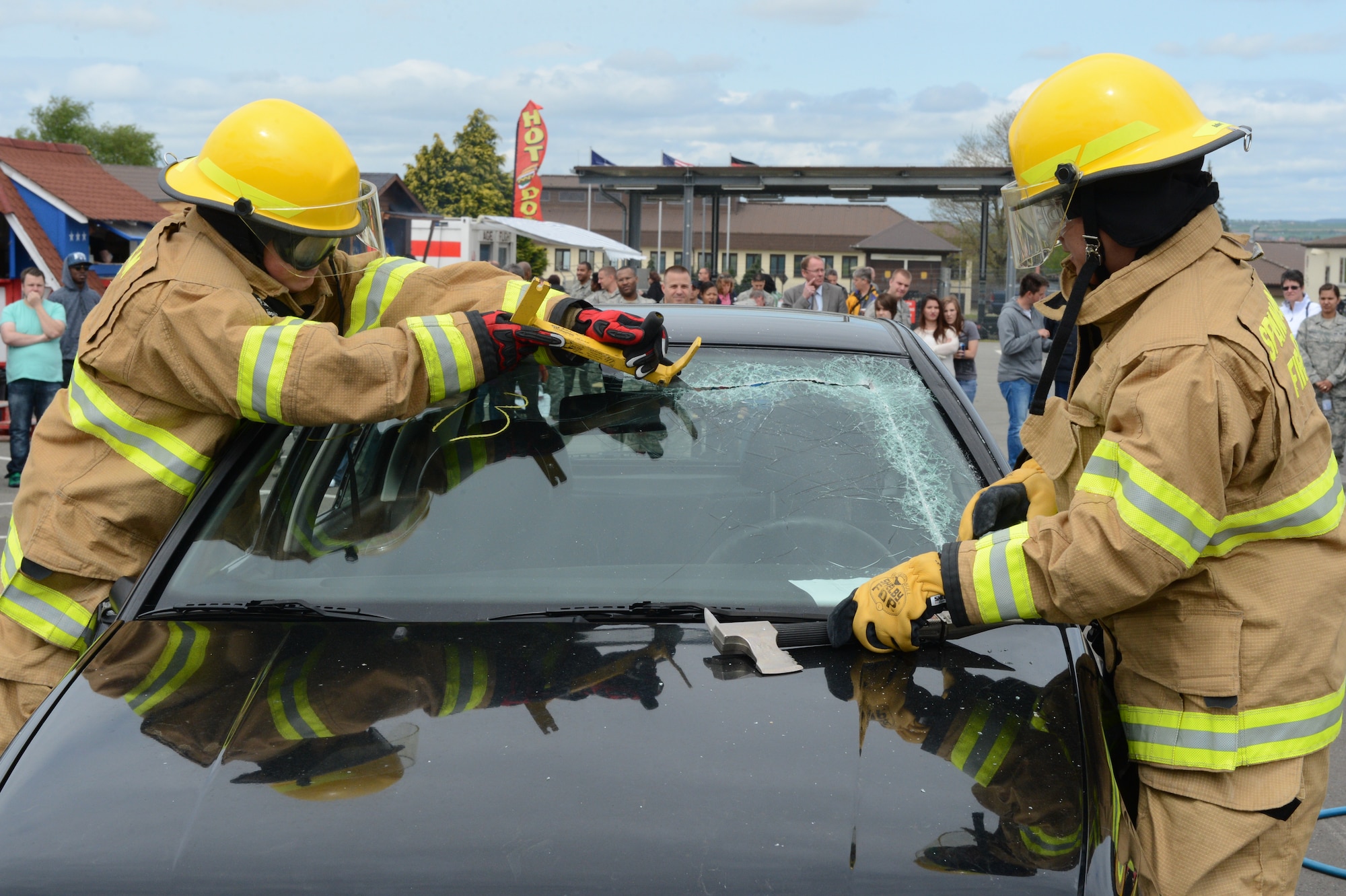 SPANGDAHLEM AIR BASE, Germany – U.S. Air Force Air Force Airmen 1st Class Jason Seavey and Gerardo Vasquez, 52nd Civil Engineer Squadron fire fighters, cut open the front windshield of a car May 10, 2013, during Spangdahlem AB’s 60th Anniversary Celebration. German visitors and guests toured the event site to see the capabilities of the 52nd Fighter Wing. (U.S. Air Force photo by Airman 1st Class Kyle Gese/Released)