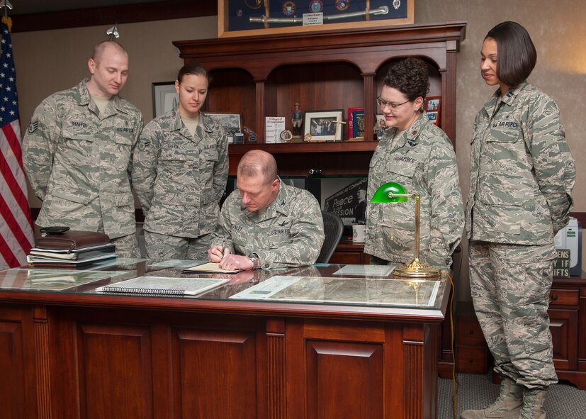 Col. Robert Stanley, 341st Missile Wing commander (center), signs a proclamation declaring May 6 through 12 Nurse and Medical Technician Appreciation Week at Malmstrom Air Force Base.  Witnessing the signing of the proclamation from left to right are Staff Sgt. Jeffrey Shaffer, 341st Medical Group medical technician; Airman 1st Class Cassidy Green, 341st Medical Operations Squadron medical technician; Maj. Ingrid Ford, 341st MDG health care integrator; and Capt. Telisha Rice, 341st MDOS member.  (U.S. Air Force photo/Beau Wade)