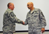 Chief Master Sgt. Michael Klausutis, right, the outgoing 919th Special Operations Wing command chief, is congratulated by his successor, Chief Master Sgt. Tom Mason, during the former’s sendoff event May 4, 2013 at Duke Field, Fla.  Since April 2009, Klausutis has served as the wing commander’s principal advisor on personnel issues affecting all 919th SOW enlisted Airmen. He was recently selected to become command chief for the new Air Force Special Operations Air Warfare Center at Hurlburt Field, Fla. (U.S. Air Force photo/Tech. Sgt. Jasmin Taylor)