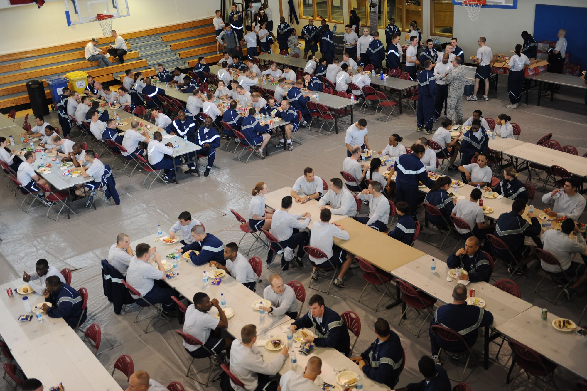 Team Mildenhall Airmen enjoy food during a post Unit Effectiveness Inspection celebration May 10, 2013, on RAF Mildenhall, England.  Afterward, Airmen participated in sports challenges that included arm wrestling, hurdles, kick ball, “Slip ‘n Slide” and tug of war. (U.S. Air Force photo by Airman 1st Class Preston Webb/Released)