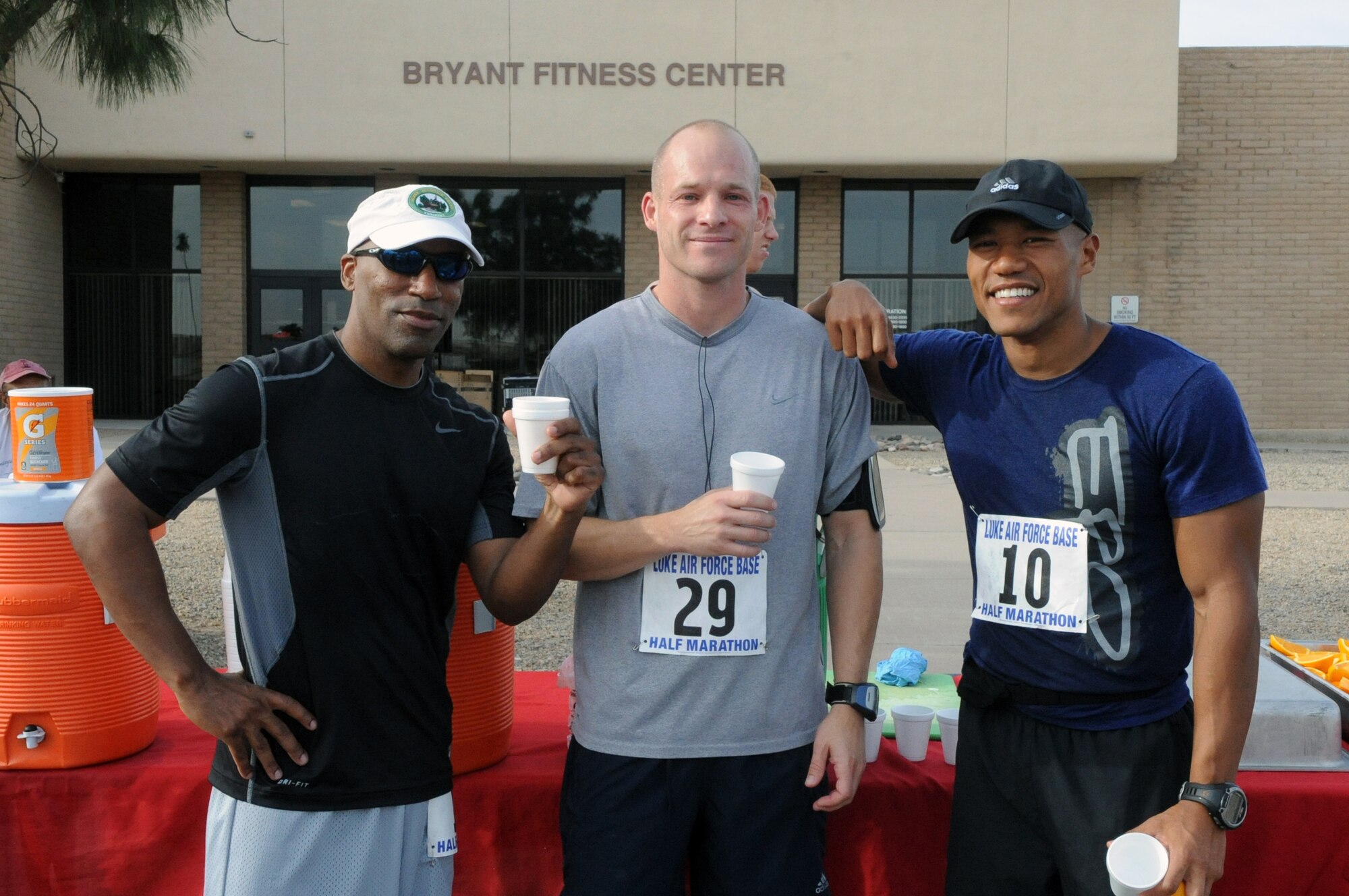 (From left to right) Eusevio Quinones, retired Navy, Tech. Sgt. Robert Amrich, 56th Component Maintenance Squadron section chief, and Maj. Siddig Mirghani, 56th AMDS public health flight commander, rehydrate after finishing the half marathon run May 4, in front of the Bryant Fitness Center at Luke Air Force Base. They were the three fastest men in the half marathon run, completing the first event for the Luke May Fitnesss Month. (U.S. Air Force photo/Airman 1st Class Pedro Mota)