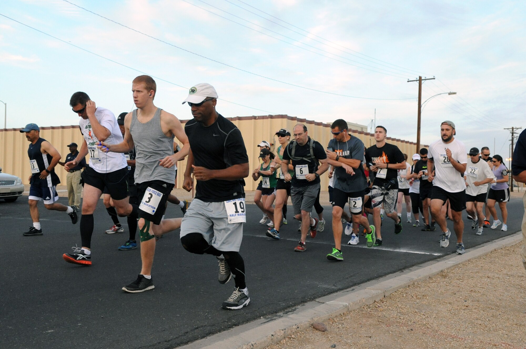 Both Military and civilians start their run in the Luke Air Force Base Half Marathon in front of the Bryant Fitness Center at Luke Air Force Base. The participants ran 13.1 miles around a set course here within a three hour window. (U.S. Air Force photo/Airman 1st Class Pedro Mota)