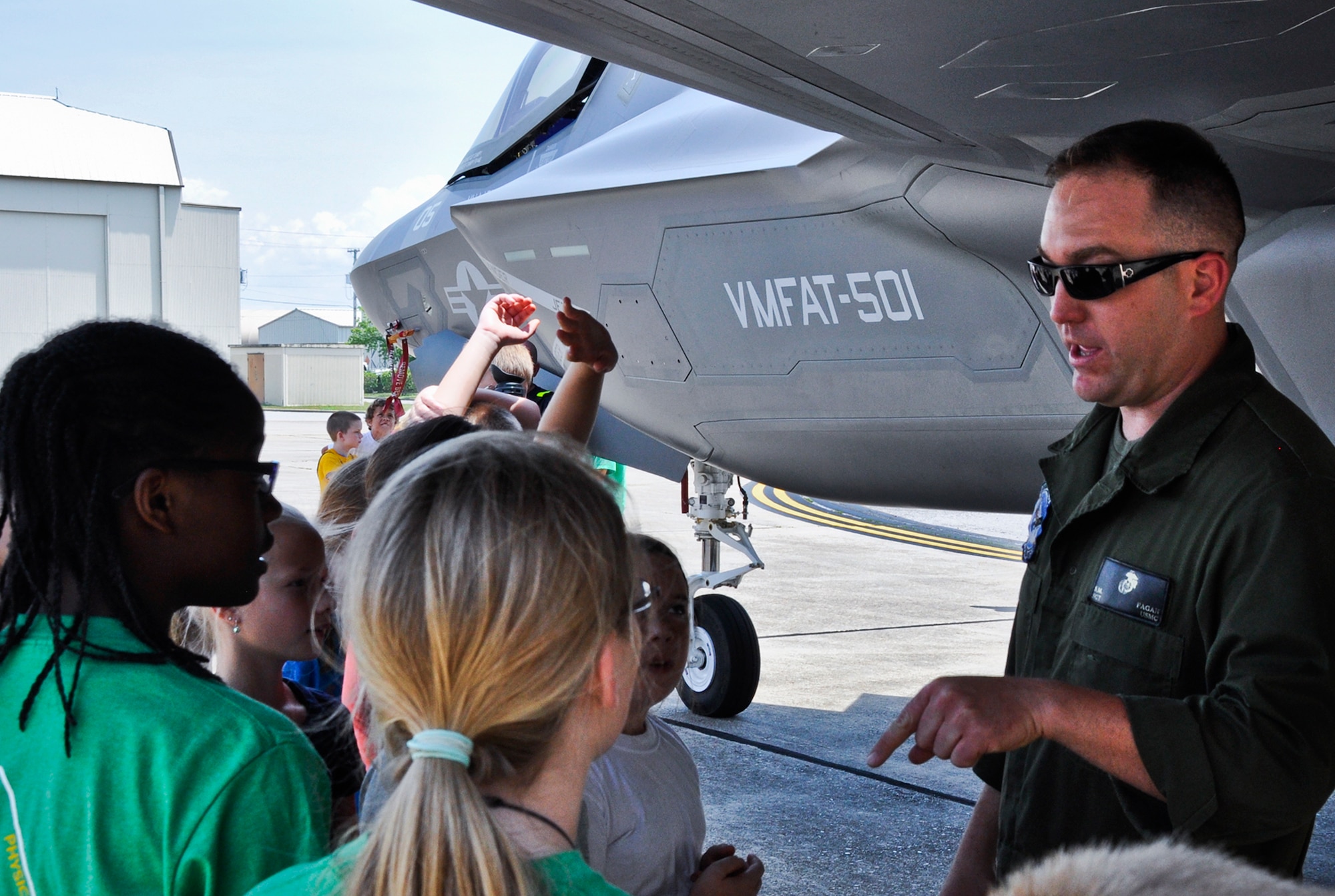 Master Sgt. Sean Fagan, a maintainer with the Marine Fighter Attack Training Squadron 501, discusses the F-35 program and jet to students as part of the Marsville program. The fifth graders had the chance to get up close to the jet and examine its different parts while asking questions of Fagan. In bringing the plane in, the VMFAT-501 marines hoped to spark the students' interest in the career fields of science, technology, engineering and math - all important parts of furthering and developing the F-35 training program at Eglin. (U.S. Air Force photo/Sara Vidoni)