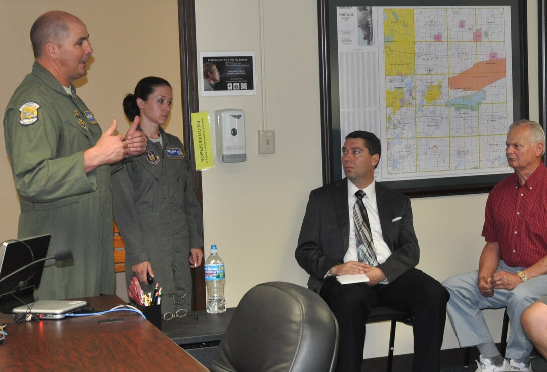 Air Force Reserve Senior Master Sgt. Bryan Watson and Master Sgt. Nicole Kehres, loadmasters with the 910th Airlift Wing, brief Portage County elected officials May 8, 2013 on the Wing’s C-130 flying mission as part of the 910th’s community outreach program.   