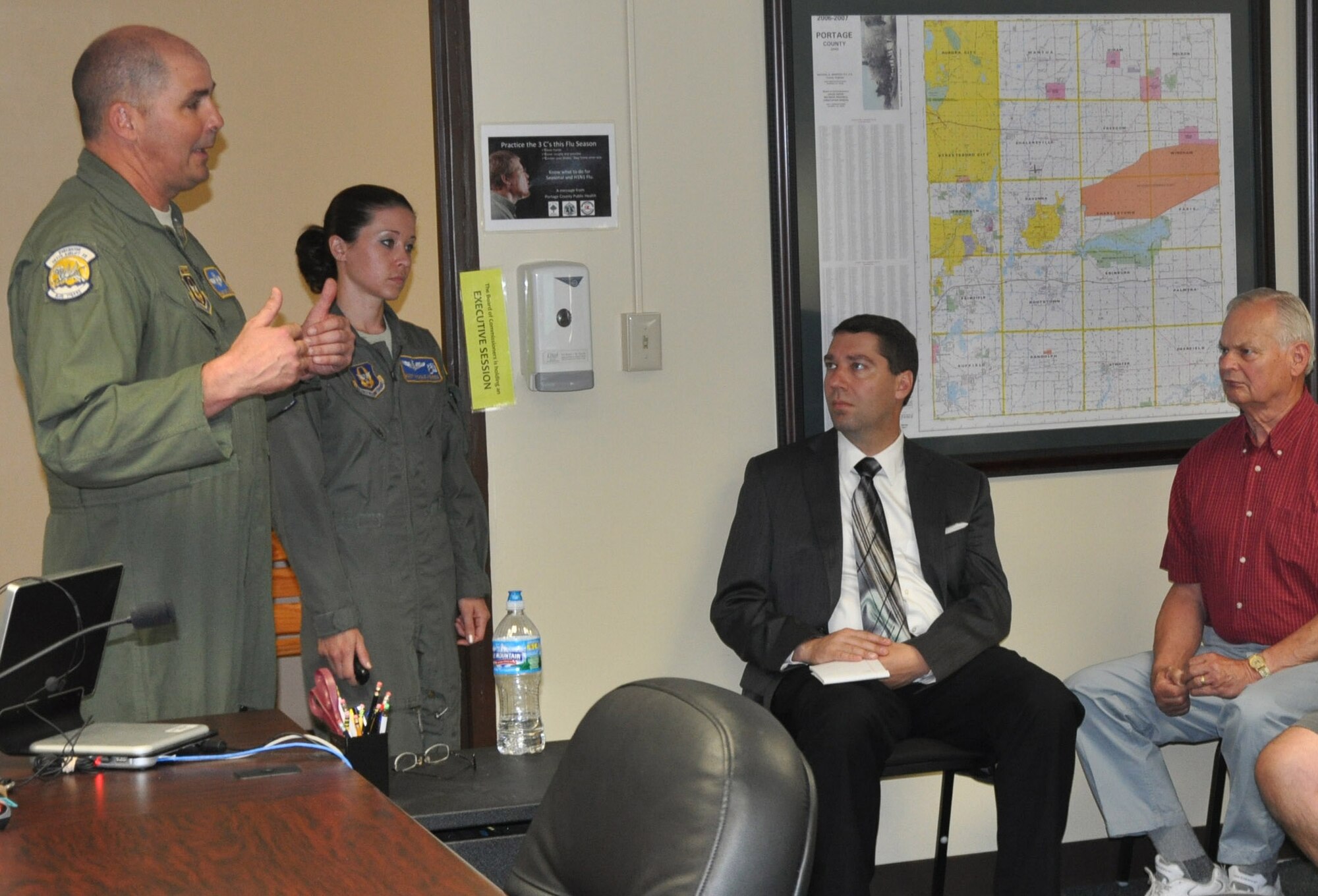Air Force Reserve Senior Master Sgt. Bryan Watson and Master Sgt. Nicole Kehres, loadmasters with the 910th Airlift Wing, brief Portage County elected officials May 8, 2013 on the Wing’s C-130 flying mission as part of the 910th’s community outreach program.   