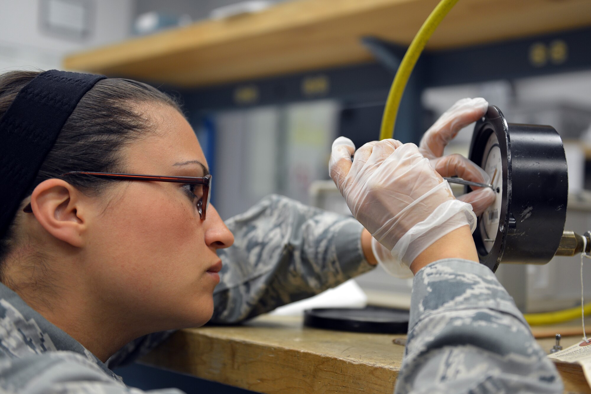 Staff Sgt. Mandy Shaddy, 62nd Maintenance Squadron Test Measurement Diagnostic Equipment Flight metrology technician, zeroes out a needle on a fuel pump pressure gauge prior to calibrating it May 8, 2013 at Joint Base Lewis-McChord, Wash. Fuel pump gauges, like these, are capable of measuring thousands of pounds of fuel and must be very accurate. (U.S. Air Force photo/Airman 1st Class Jacob Jimenez)