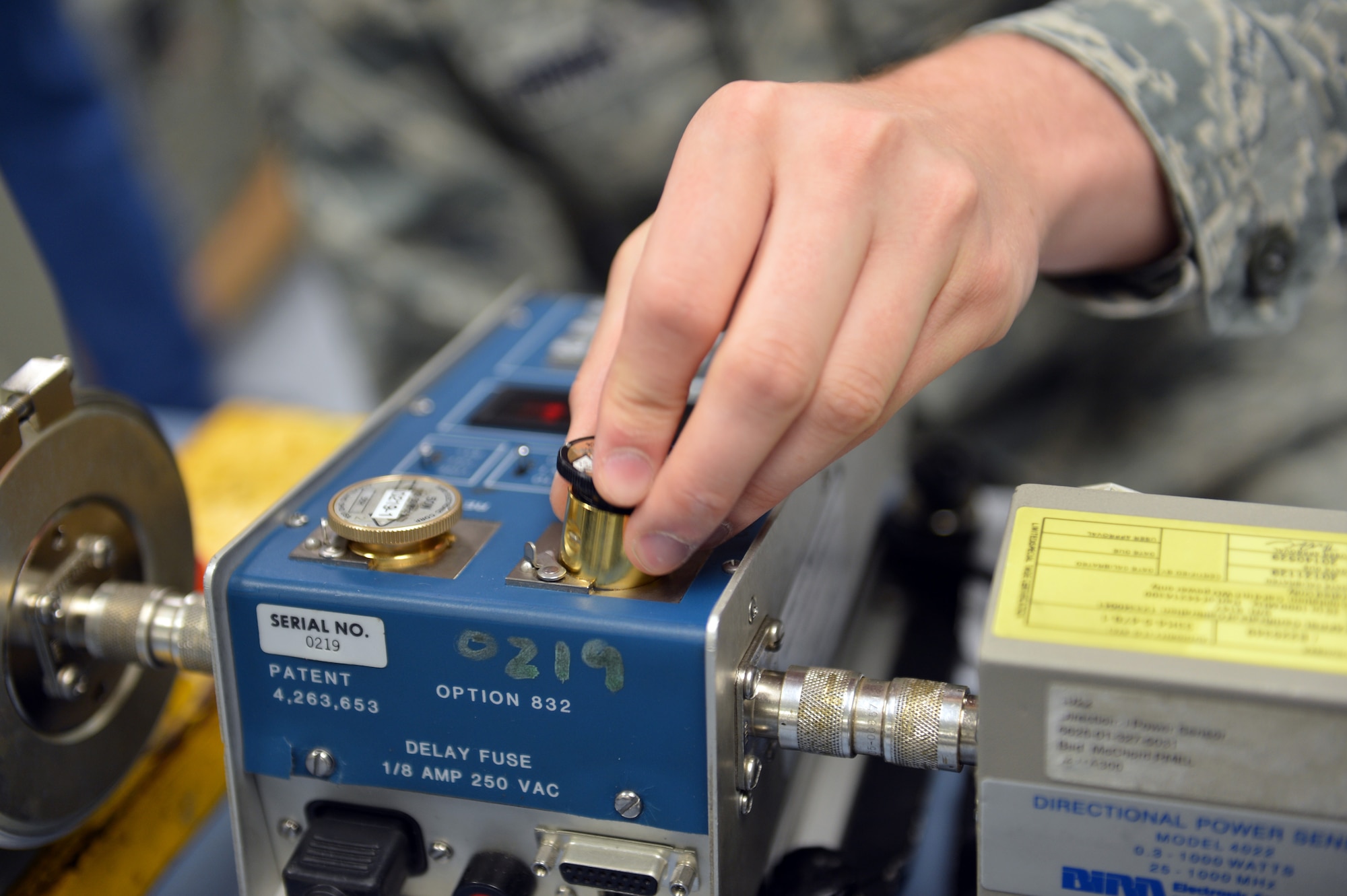 Senior Airman Jacob Burns, 62nd Maintenance Squadron Test Measurement Diagnostic Equipment Flight metrology technician, inserts an element into a wattmeter May 8, 2013 at Joint Base Lewis-McChord, Wash. Elements are used in the calibration of a wattmeter by verifying the measurement reading of the meter when a known amount of wattage is inputted. (U.S. Air Force photo/Airman 1st Class Jacob Jimenez)