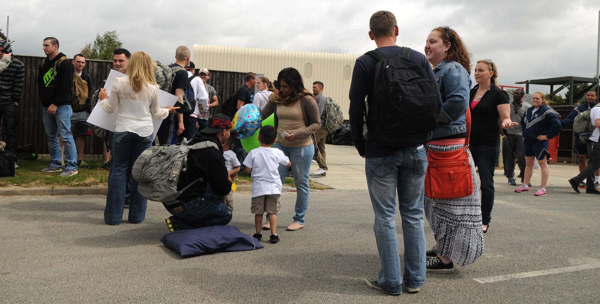 Family and friends greet members of the 100th Security Forces Squadron who have just arrived home from a deployment May 10, 2013, at RAF Mildenhall, England. About 30 defenders from the 100th SFS were deployed to multiple locations worldwide for about six months, and returned safely to smiles, hugs and handshakes from loved ones and coworkers. (U.S. Air Force photo/Staff Sgt. Austin M. May/Released)