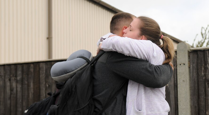 Senior Airman Colton Ryan, 100th Security Forces Squadron response force member, embraces his wife, Avery, upon returning home from a deployment May 10, 2013, at RAF Mildenhall, England. Ryan, from Hunt, Texas, was one of more than 30 defenders from the 100th SFS who deployed to support various missions across the globe. (U.S. Air Force photo/Staff Sgt. Austin M. May/Released)