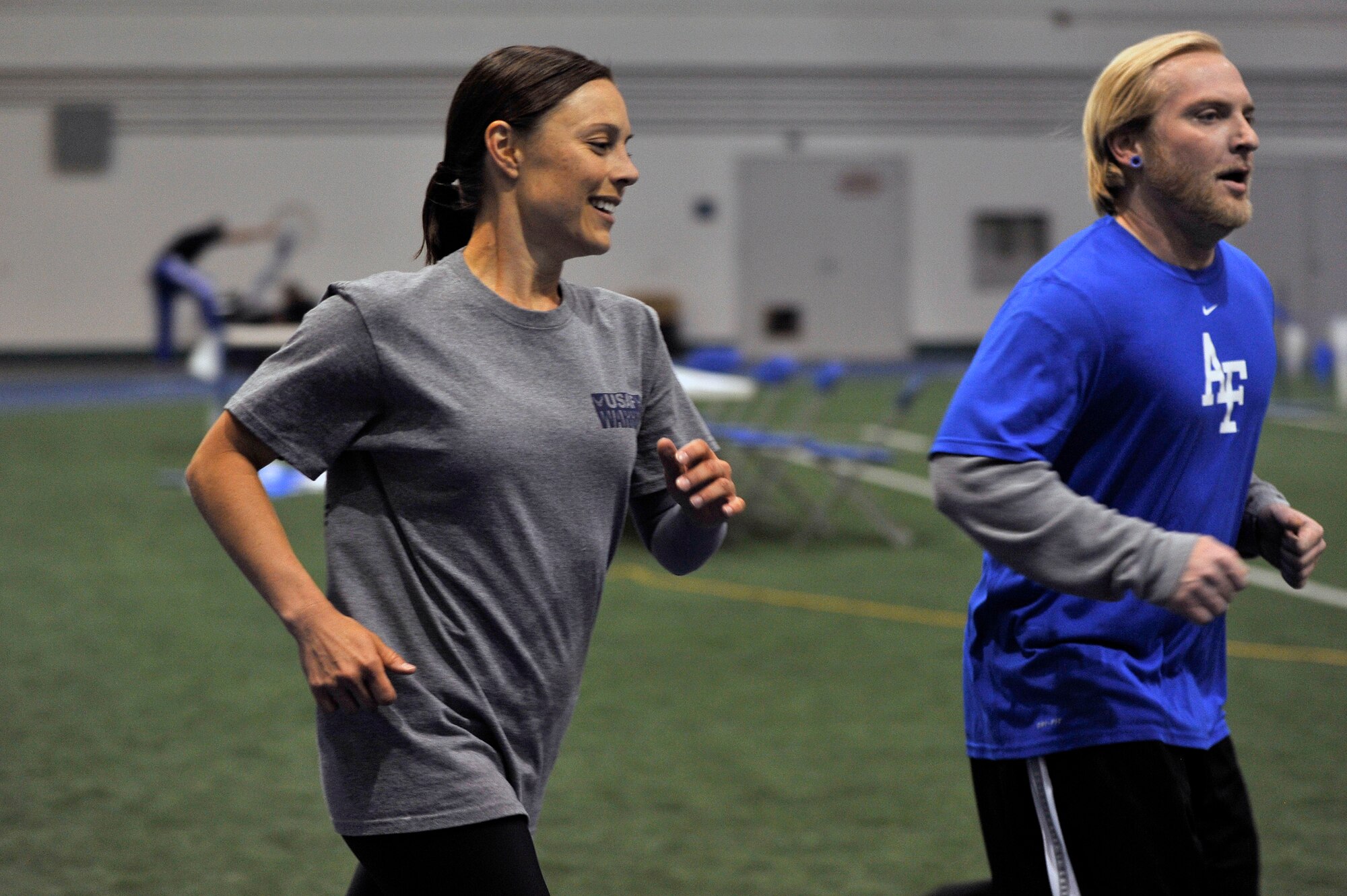 Staff Sgt. Lara Ishikawa and Senior Airman Gene Gatzert  run laps at the Academy indoor track during the Wounded Warrior Games Training Camp held in Colorado Springs, Colo., April 18, 2013. Ishikawa is stationed at Joint Base San Antonio-Lackland. (U.S. Air Force photo/Desiree N. Palacios)