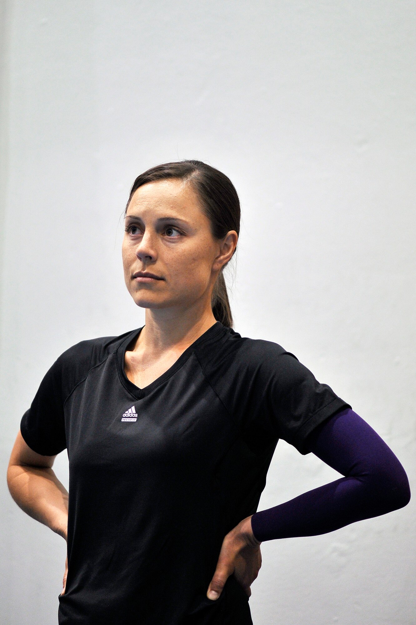 Staff Sgt. Lara Ishikawa listens to her coach speak before running laps at the Academy indoor track during the Wounded Warrior Games Training Camp held in Colorado Springs, Colo., April 17, 2013. Ishikawa is stationed at Joint Base San Antonio-Lackland. (U.S. Air Force photo/Desiree N. Palacios)
