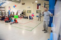 Staff Sgt. Darrell Williams, 902nd Security Forces Squadron Military Working Dog handler, gives children from Randolph Elementary School their mission brief for Operation FLAGS May 2 at Joint Base San Antonio-Randolph. (Air Force photo by Joshua Rodriguez/ Released)