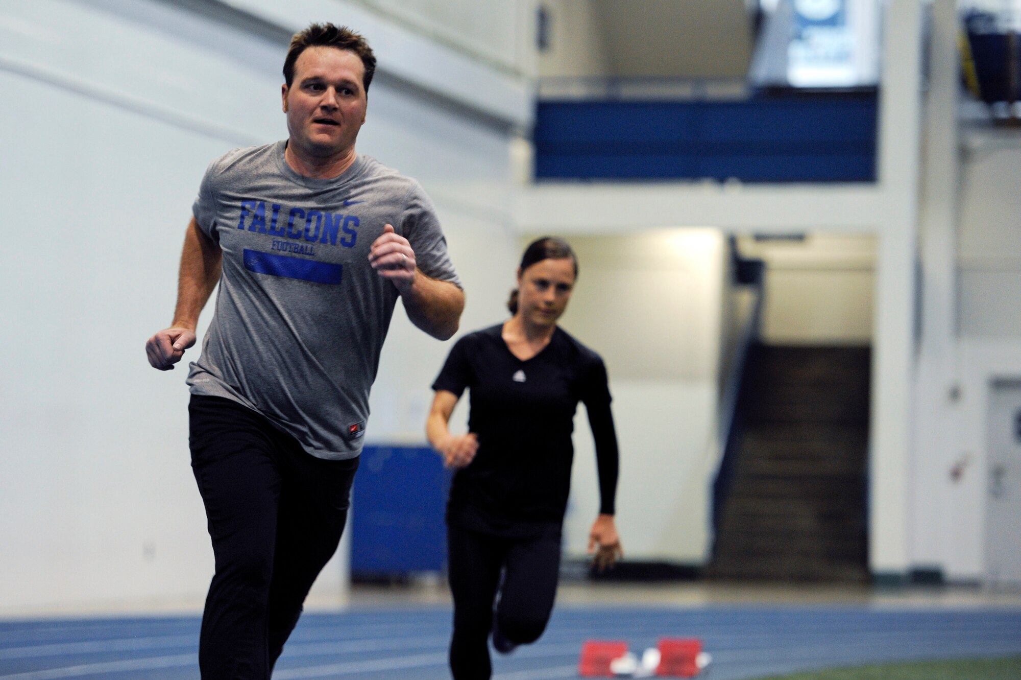 Capt. Wesley Glisson and Staff Sgt. Lara Ishikawa run laps at the Academy indoor track during the Wounded Warrior Games Training Camp held in Colorado Springs, Colo., April 19, 2013. Glisson and Ishikawa are assigned to Joint Base San Antonio-Lackland. (U.S. Air Force photo/Desiree N. Palacios)

