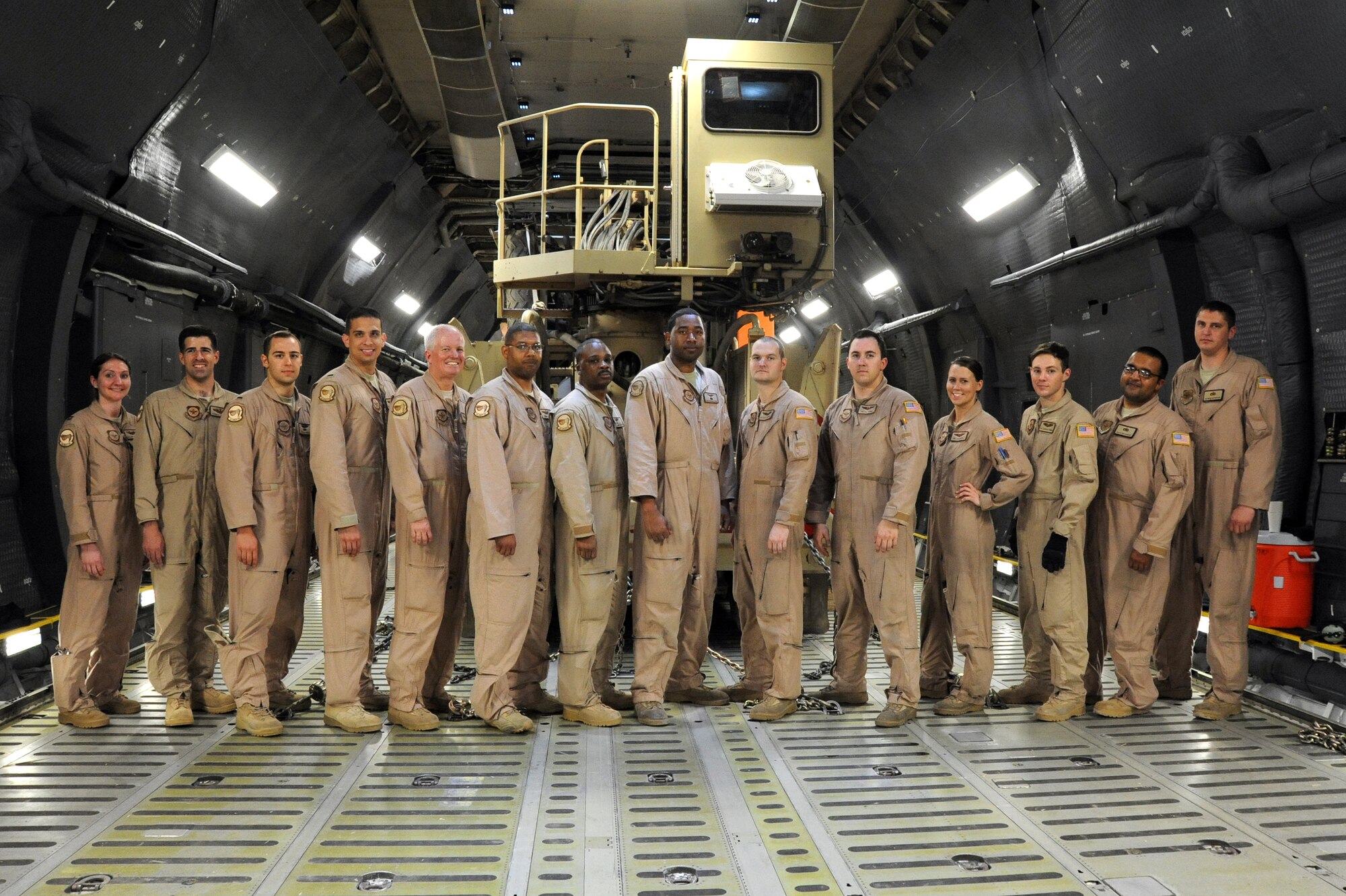 The 9th Airlift Squadron, Dover Air Force based C-5M Super Galaxy crew that carried out the historic 87,000 pound Granutech Mobile Rotogrind Shredder Model 525 HP validation load. Capt. Mallory Swiderski, Capt. Thomas Moseder, 1st Lt. Derek Jones, 1st Lt. Alejandro Reyes, Chief Master Sgt. Richard Brackett, Tech. Sgt. Junius Reid, Master Sgt. Bobby Walker, Tech. Sgt. Antonio Little, Senior Airman Cody Caprenter, Senior Airman Zachary Fannin, Senior Airman Julia Hatch, Airman 1st Class Colt Wiens, Staff Sgt. Matthew Betancourt and Staff Sgt. Bryan Mattheessen at an undisclosed airfield, Southwest Asia May 8, 2013. (U.S. Air Force photo/Senior Master Sgt. George Thompson)