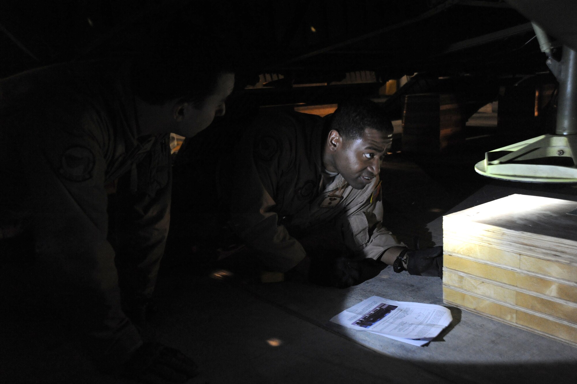 Senior Airman Zac Fannin and Tech. Sgt Antonio Little, 9th Airlift Squadron, Dover Air Force Base, Del., loadmasters ensure the shoring material is in prper position before loading the 87,000 pound Granutech Mobile Rotogrind Shredder Model 525 HP into a C-5M Super Galaxy May 8, 2013 at an undisclosed airfield, Southwest Asia. (U.S. Air Force photo/Senior Master Sgt. George Thompson)