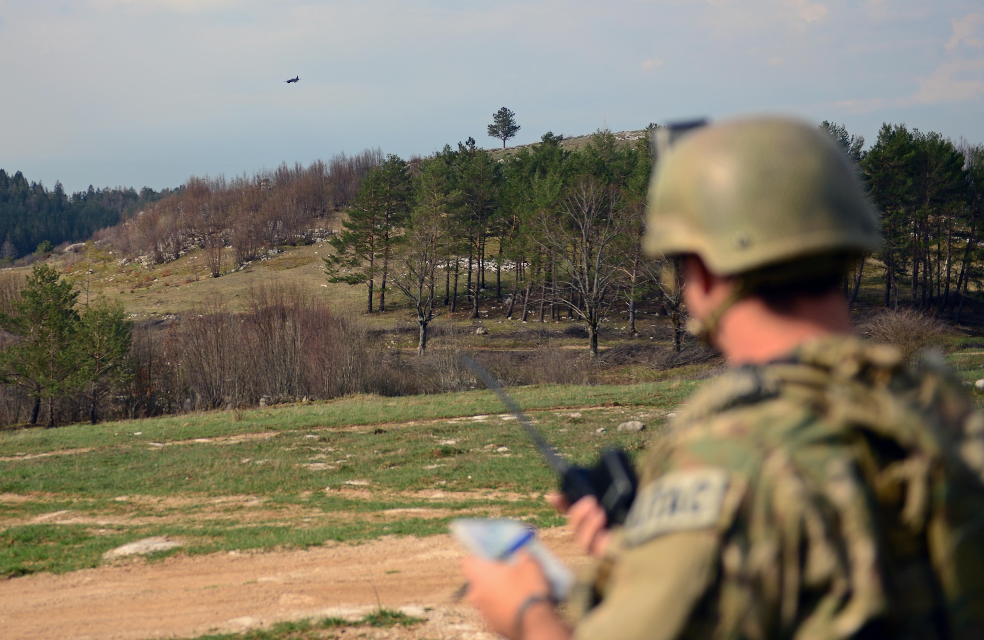First Lt. Patrick Bonner, 8th Air Support Operations Squadron tactical air control party air liaison officer, radios a Slovenian pilot April 19, 2013, at a training range in Pocek, Slovenia. Joint training missions help TACP members develop combat-related skills such reading a map, using a compass, targeting an enemy location, and surviving, escaping and evading techniques. (U.S. Air Force photo/Airman 1st Class Matthew Lotz)