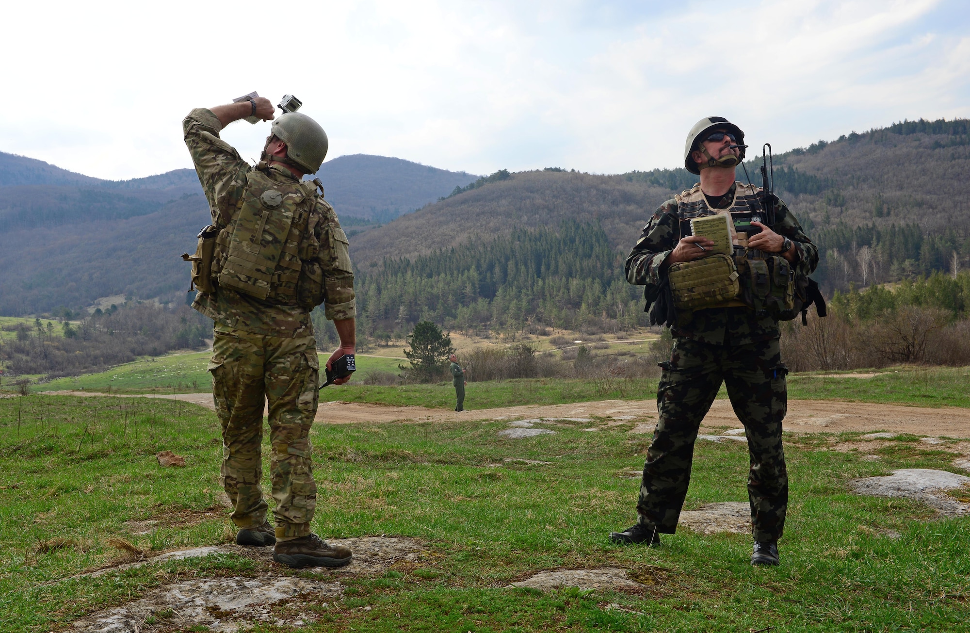 First Lt. Patrick Bonner, 8th Air Support Operations Squadron tactical air control party air liaison officer, and Slovenian army Staff Sgt. Rudolf Rot, joint terminal attack controller instructor, look for a Slovenian PC-9M aircraft April 19, 2013, at a training range in Pocek, Slovenia. U.S. Air Force TACPs train with other allied countries to help maintain proficiency with cutting-edge technology, including communications, computers, digital networks, targeting and surveillance equipment. (U.S. Air Force photo/Airman 1st Class Matthew Lotz)