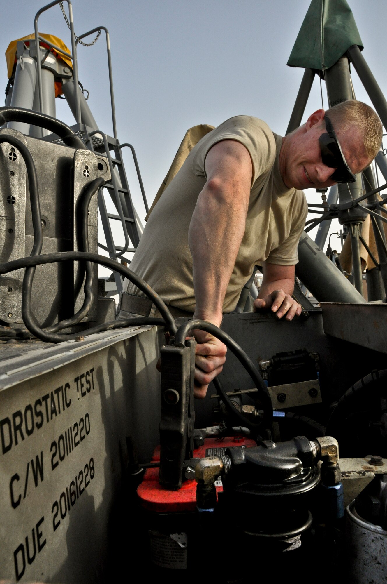 U.S. Air Force Senior Airman Brian Bloomer, 380th Expeditionary Maintenance Squadron Aerospace Ground Equipment journeyman, connects jumper cables May 9, 2013, to a low pressure air compressor. In addition to delivering equipment to the aircraft maintainers as needed, AGE flightline drivers perform minor maintenance actions to keep equipment mission ready. Bloomer is a native of Maquon, Ill., and is deployed from Mountain Home Air Force Base, Idaho. (U.S. Air Force photo by Staff Sgt. Timothy Boyer)