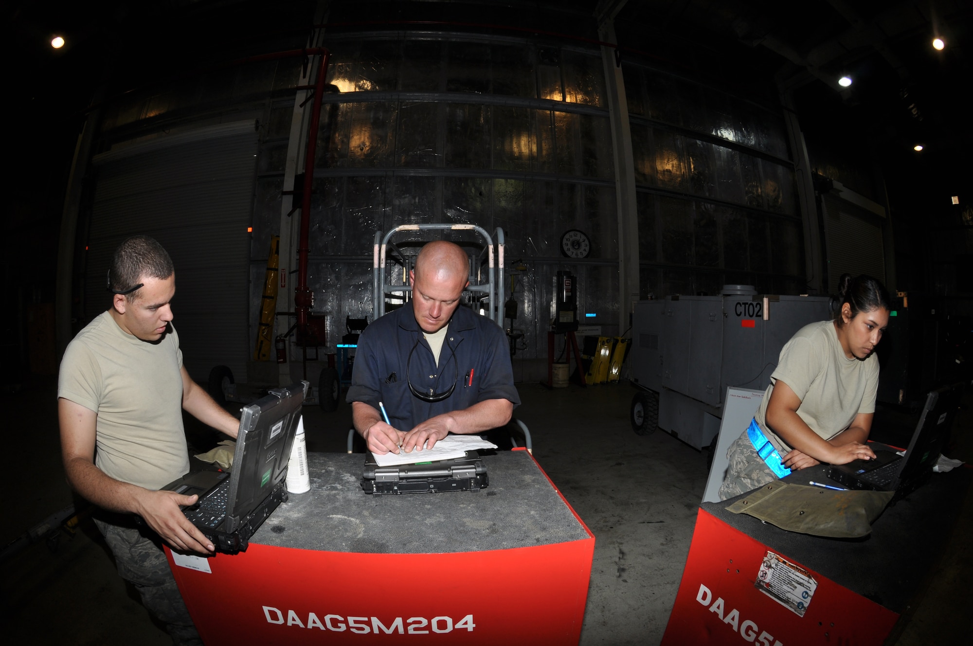 U.S. Air Force Airman 1st Class Christopher Maglio, 380th Expeditionary Maintenance Squadron Aerospace Ground Equipment journeyman, left, U.S. Air Force Staff Sgt. David Toman, 380 EMXS AGE craftsman, center, and U.S. Air Force Airman 1st Class Anna Martinez, 380 EMXS AGE journeyman, right, open their digital technical orders and toolboxes in preparation for a hard day's work May 8, 2013, here. The 380 EMXS AGE shop performs an average of 600 maintenance actions and 150 periodic inspections monthly. Maglio, a Wheatfield, Ind., native is deployed from Mountain Home Air Force Base, Idaho. Toman, a Bismarck, N.D., native is also deployed from Mountain Home AFB, Idaho. Martinez, a Highland, Calif., native is deployed from Tinker Air Force Base, Okla. (U.S. Air Force photo by Staff Sgt. Timothy Boyer)