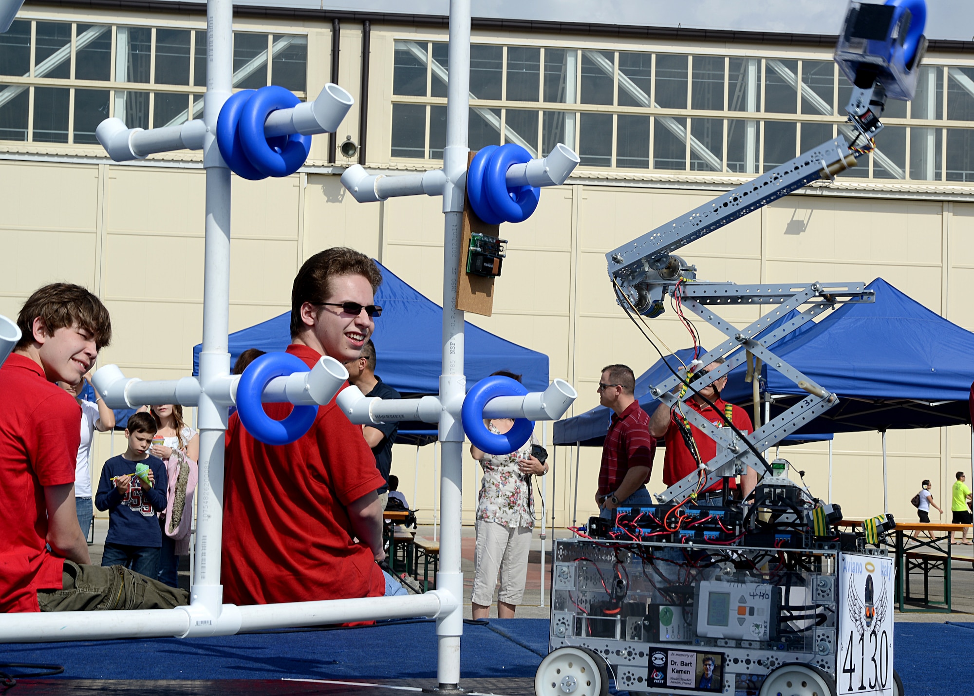 Songar Ideus (left) and Nathaniel Schaul (right),Aviano Robotics Team coaches, observe as other members of the ART perform a domonstation at Aviano Air Base, Italy, May 4.  The ART made history as the first Department of Defense Education Activities robotics team to make it the world  robotics championship in St. Louis April 23-27.(U.S. Air Force photo/Staff Sgt. Ryan Whitney)