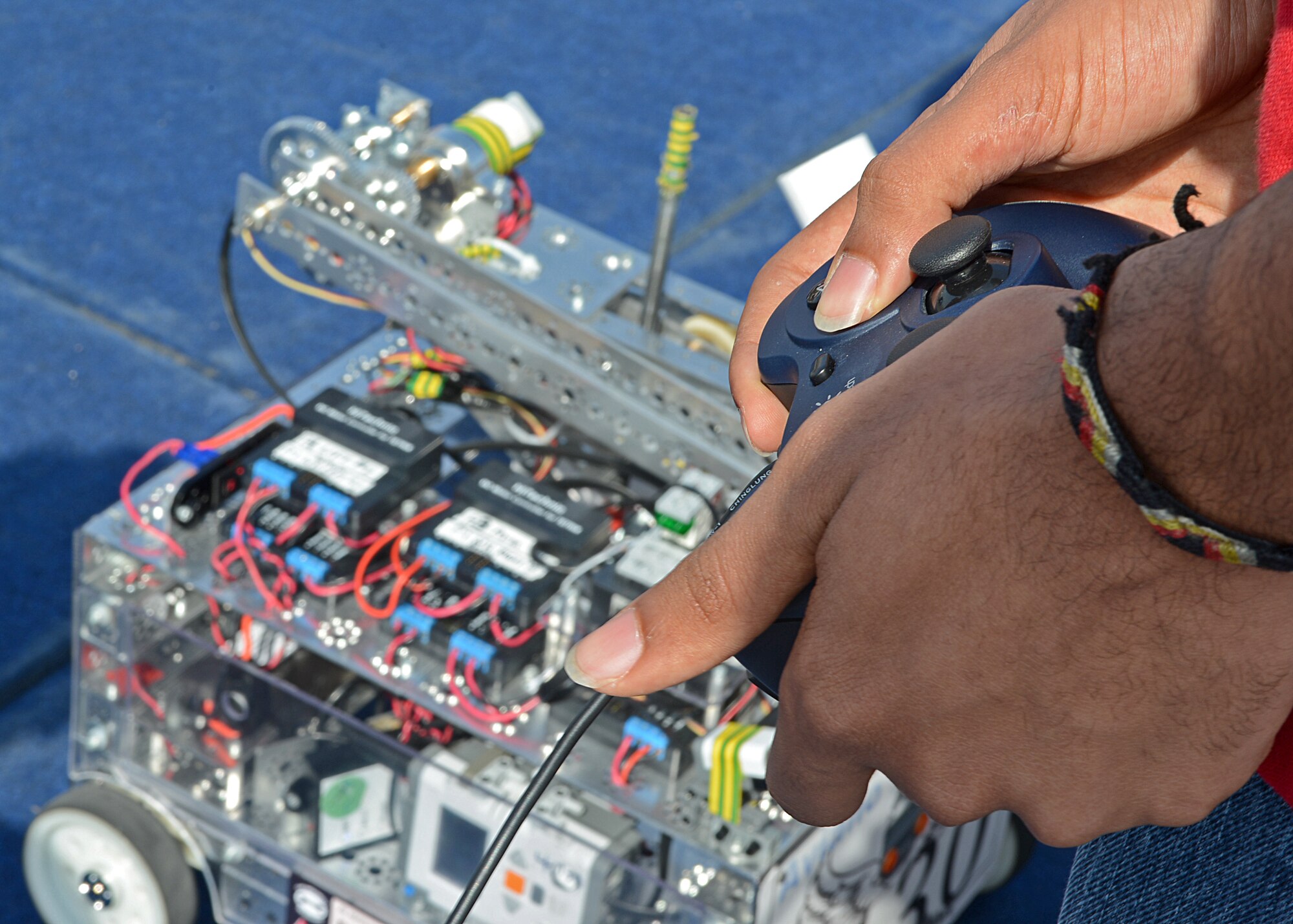 Marquell Burks, Aviano Robotics Team president, controls Robotica Santi during a demonstration at Aviano Air Base, Italy, May 4. In there first year of competing,  the Aviano Robotics Team won the regional competition in Germany, and went on to compete in the world championship in St. Lois April 23-27.(U.S. Air Force photo/Staff Sgt. Ryan Whitney)