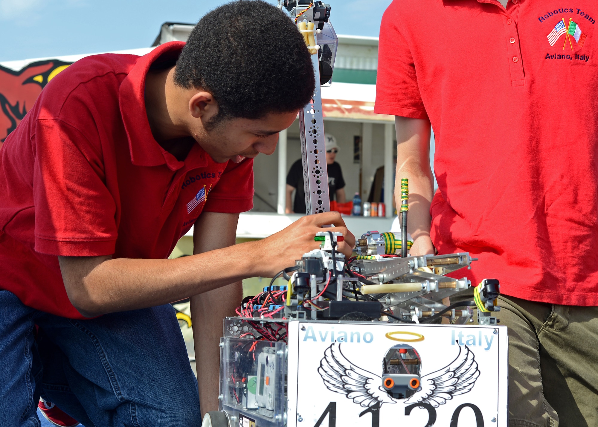Marquell Burks, Aviano Robotics Team president, inspects Robotica Santi prior to a demonstration at Aviano Air Base, Italy, May 4. In there first year of competing,  the Aviano Robotics Team won the regional competition in Germany, and went on to compete in the world championship in St. Lois April 23-27.(U.S. Air Force photo/Staff Sgt. Ryan Whitney)