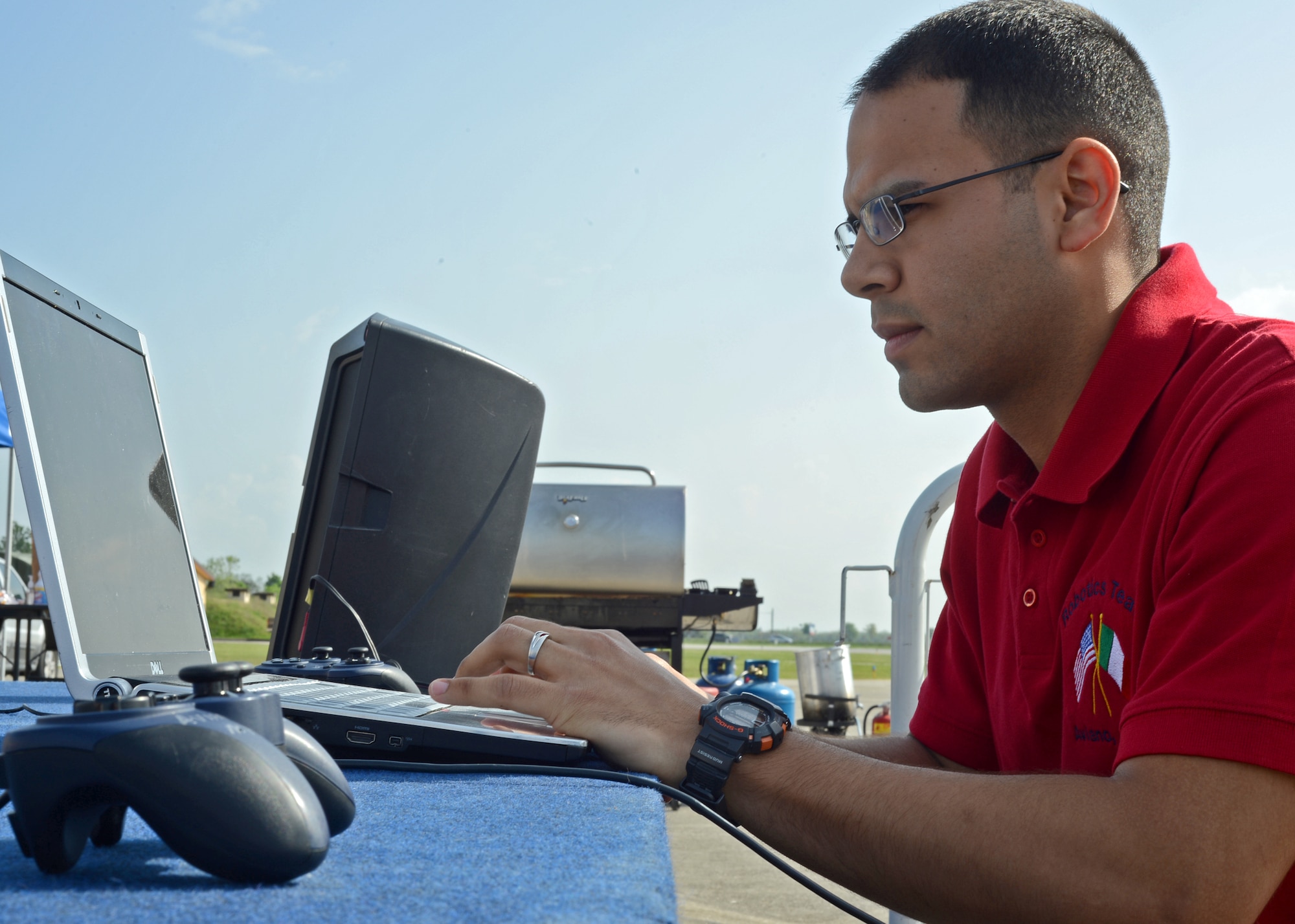 Airman 1st Class Karlos Collazo-Ortiz, Aviano Robotics Team mentor, prepares the wireless signal that controls Robotica Santi during a demonstation May 4, at Aviano Air Base, Italy.  The Aviano Robotics Team became the first Department of Defense Education Activities team to compete in the F.I.R.S.T. Robotics World Championship in St. Louis April 23-27.(U.S. Air Force photo/Staff Sgt. Ryan Whitney)