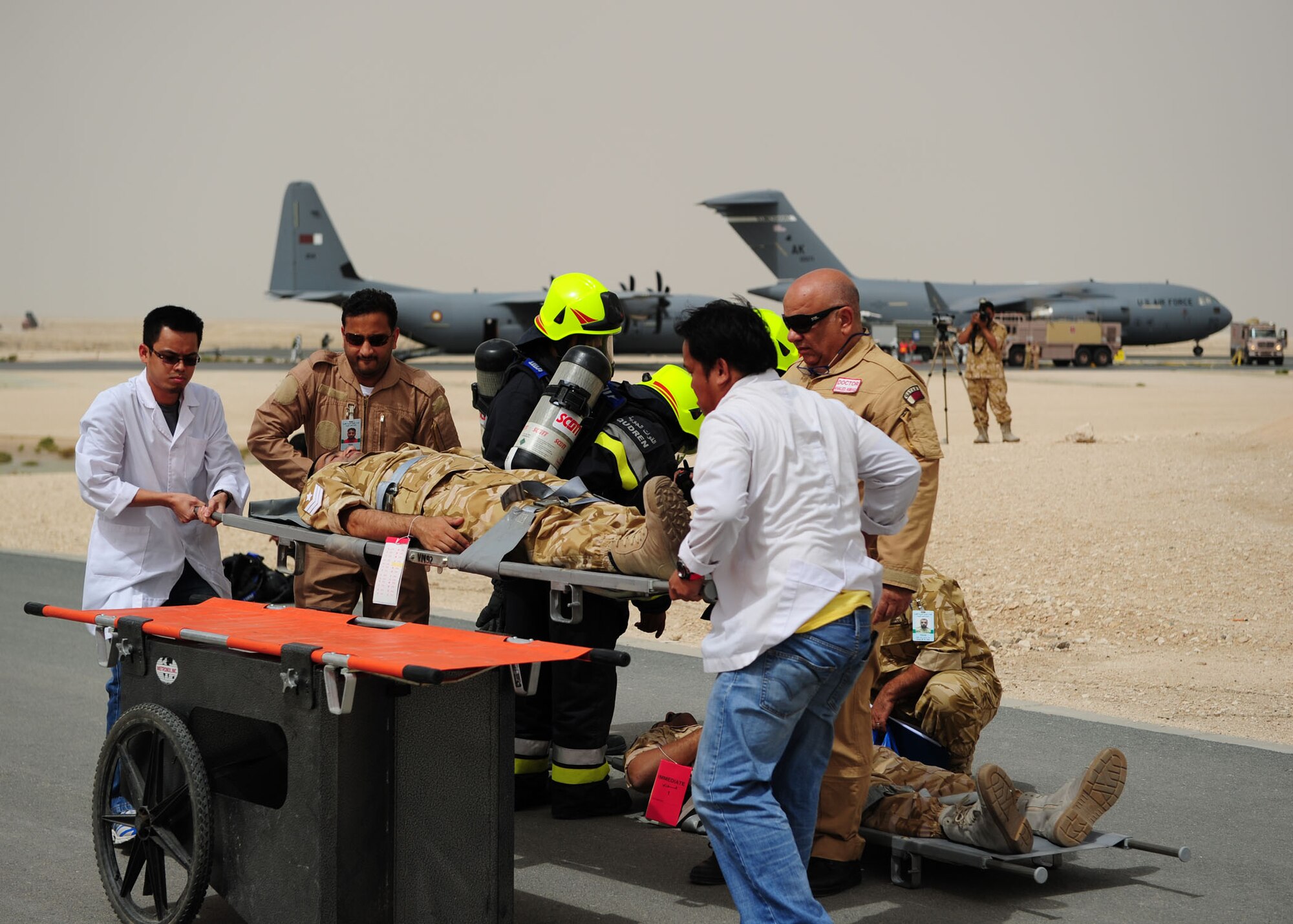 SOUTHWEST ASIA -- Host nation emergency personnel load a simulated critical care patient onto stretcher carrier before moving him to be triaged during the first joint host nation and U.S. major accident response exercise here May 6. The MARE showcased how host nation and U.S. military work together in an emergency response event.  (U.S. Air Force photo/Master Sgt Brendan Kavanaugh)
