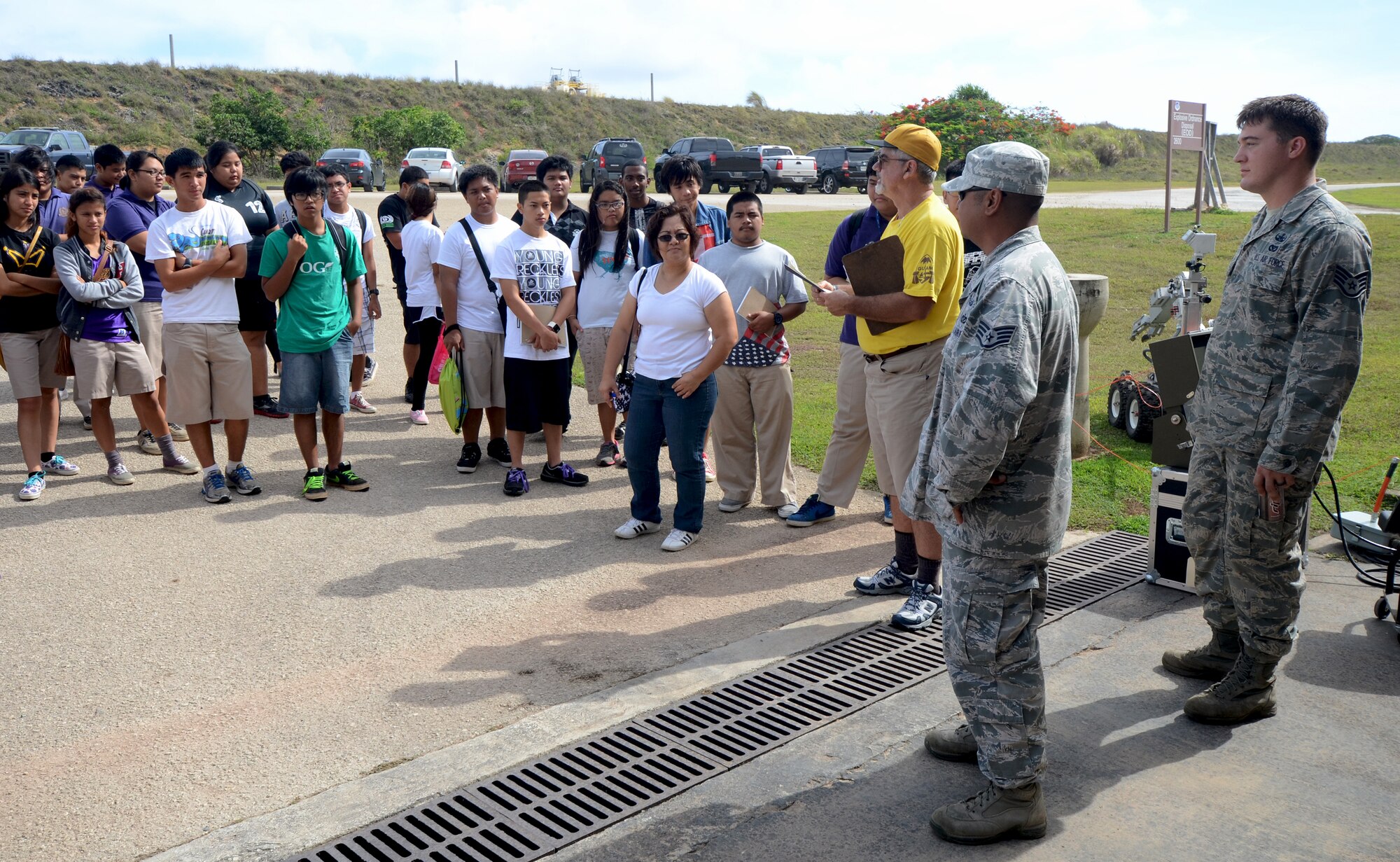 Staff Sgt. John Blas, 36th Civil Engineer Squadron Explosive Ordnance Disposal operations NCO in charge, greets George Washington High School students as they arrive at the EOD complex on Andersen Air Force Base, Guam, May 1, 2013. Forty-Three students took a field trip to the complex as part of their current history curriculum in World War II history and the Pacific Islands. (U.S. Air Force photo by Staff Sgt. Benjamin Wiseman/Released)