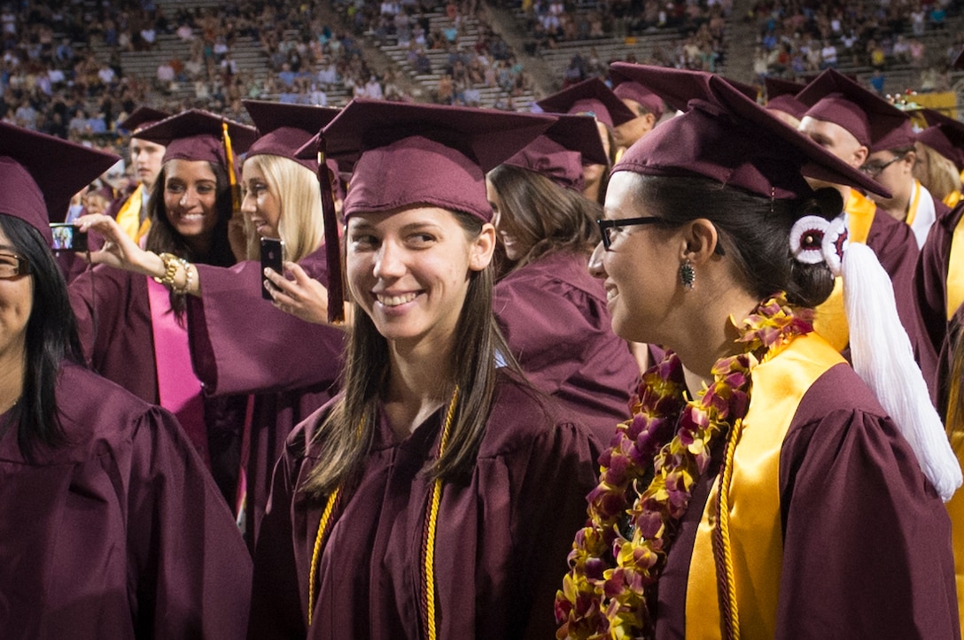 Graduates of the Arizona State University Class of 2013 smile during their graduation ceremony in Tempe, Ariz., May 9, 2013. 